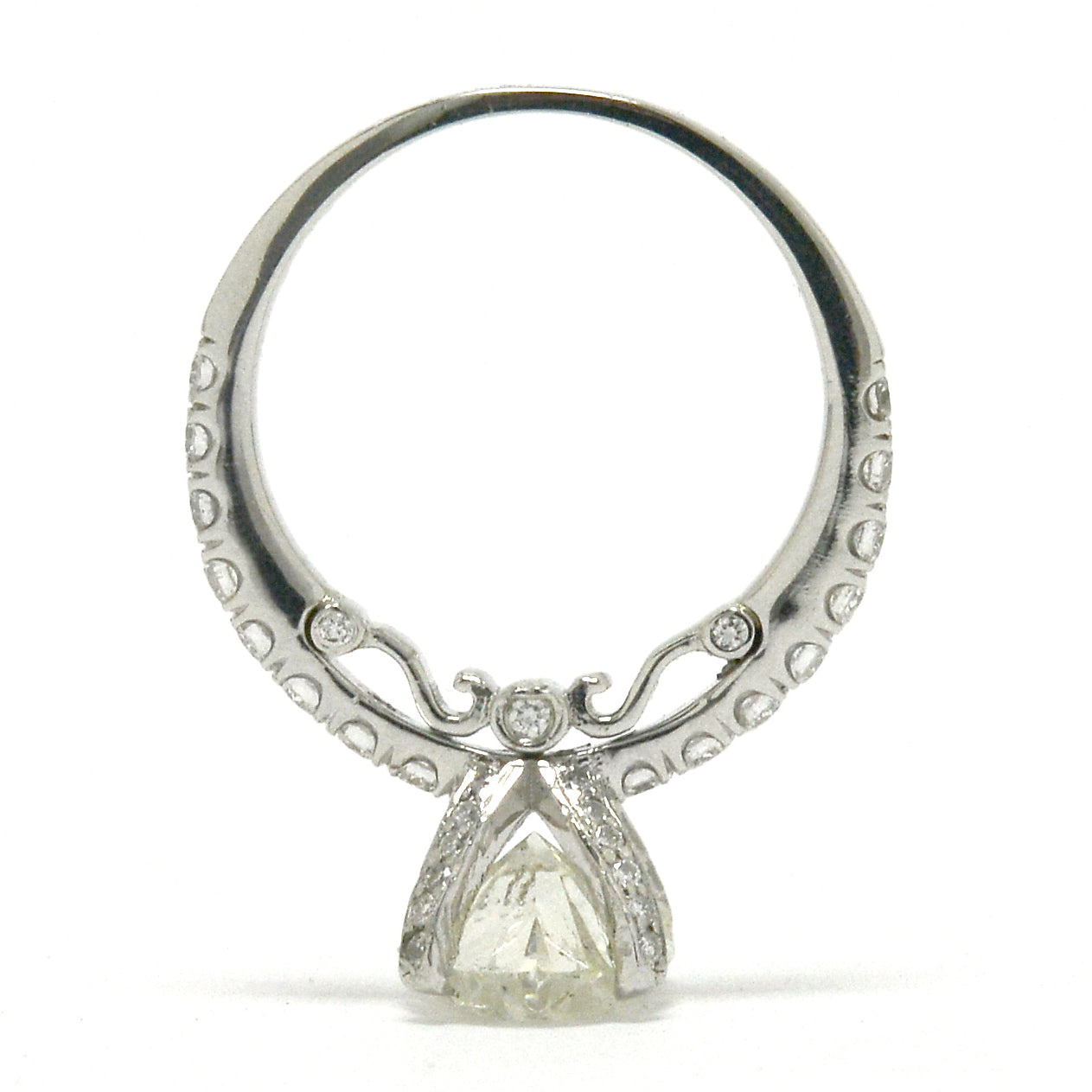 A scroll and diamonds underneath the solitaire ring's gallery.