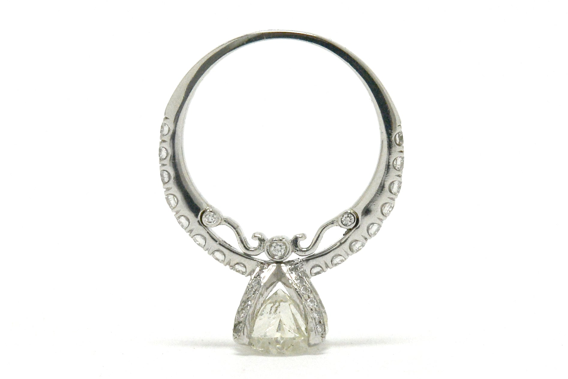 A scroll and diamonds underneath the solitaire ring's gallery.