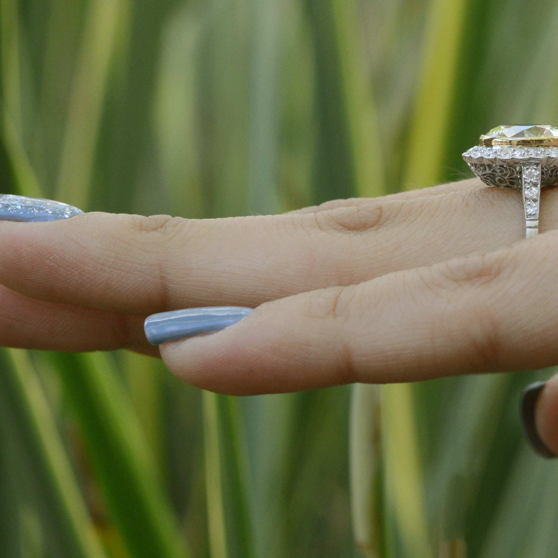 A yellow with vvs clarity diamond halo engagement ring.