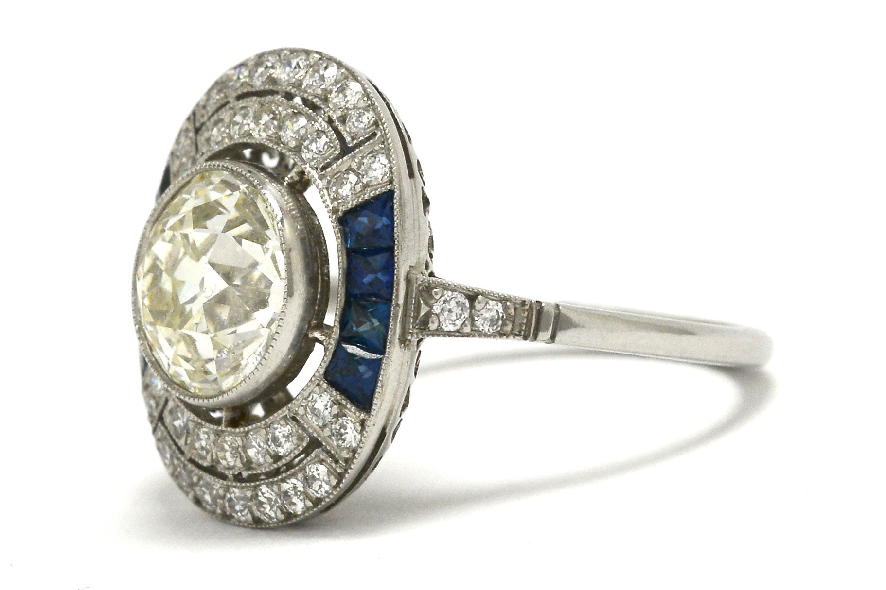 An antique diamond is set in an Art Deco revival engagement ring.