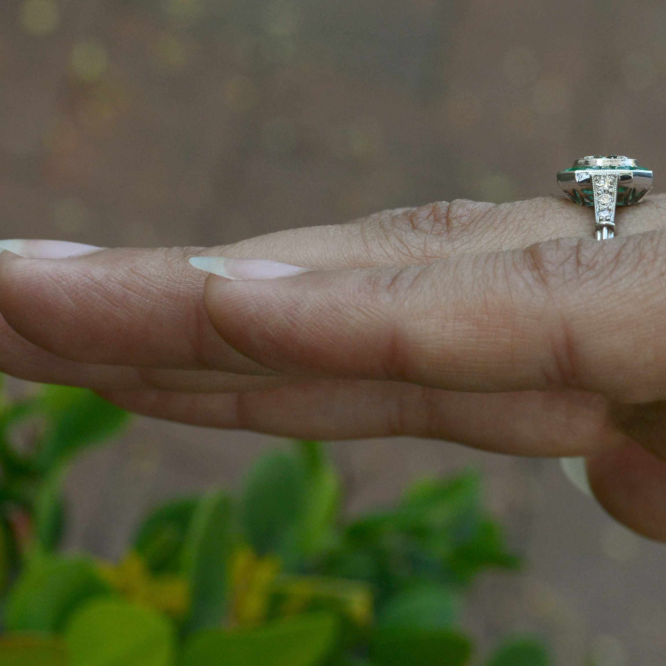 A diamond emerald wedding ring with diamonds on the shank.