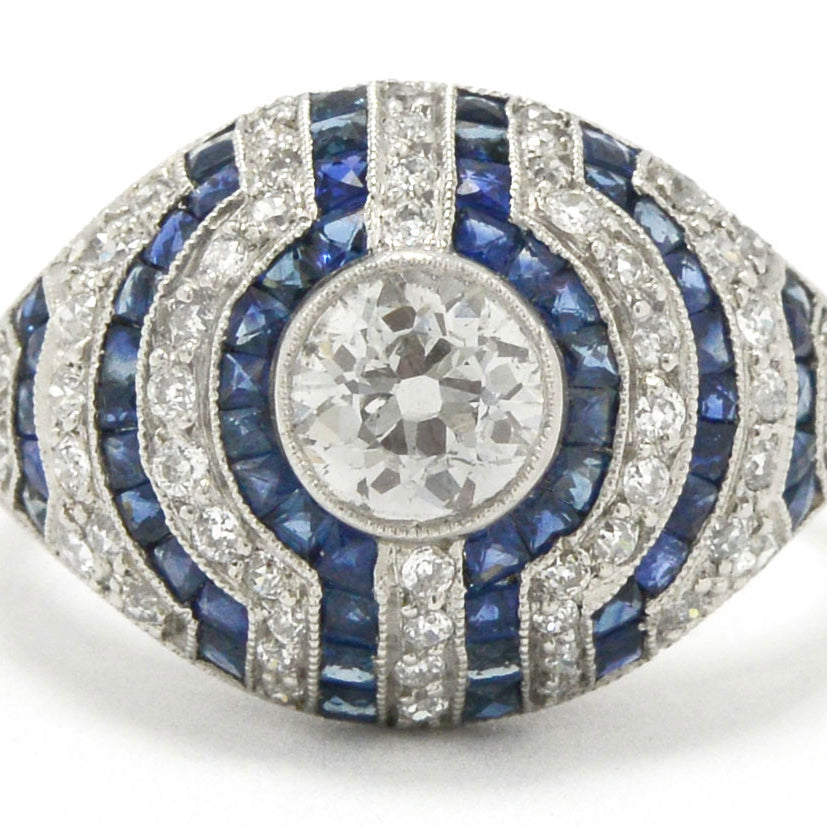 A stripe pattern diamond and blue sapphires engagement ring.
