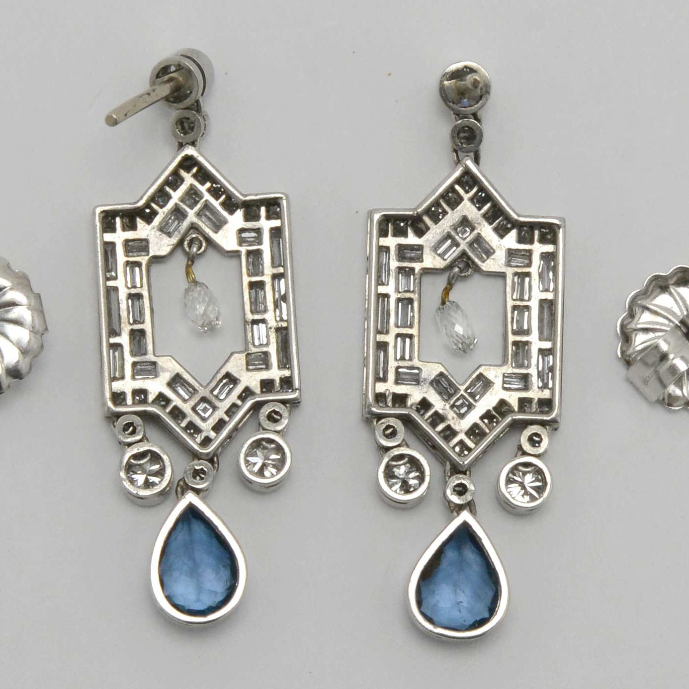 An alhambra design window aqua earrings with a free floating briolette diamond.