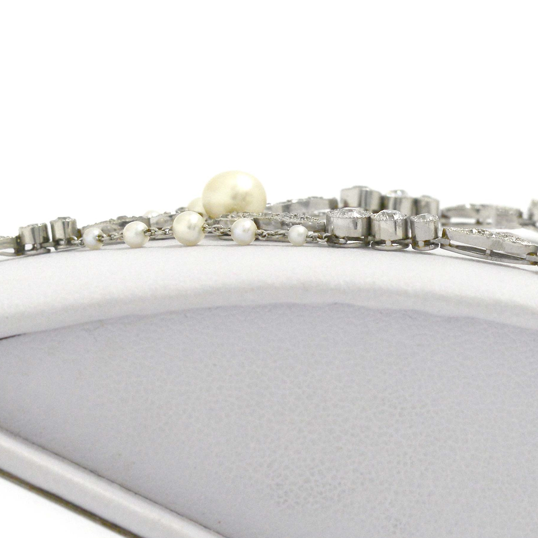 Pearls and diamonds line this filigree platinum Art Nouveau negligee necklace.