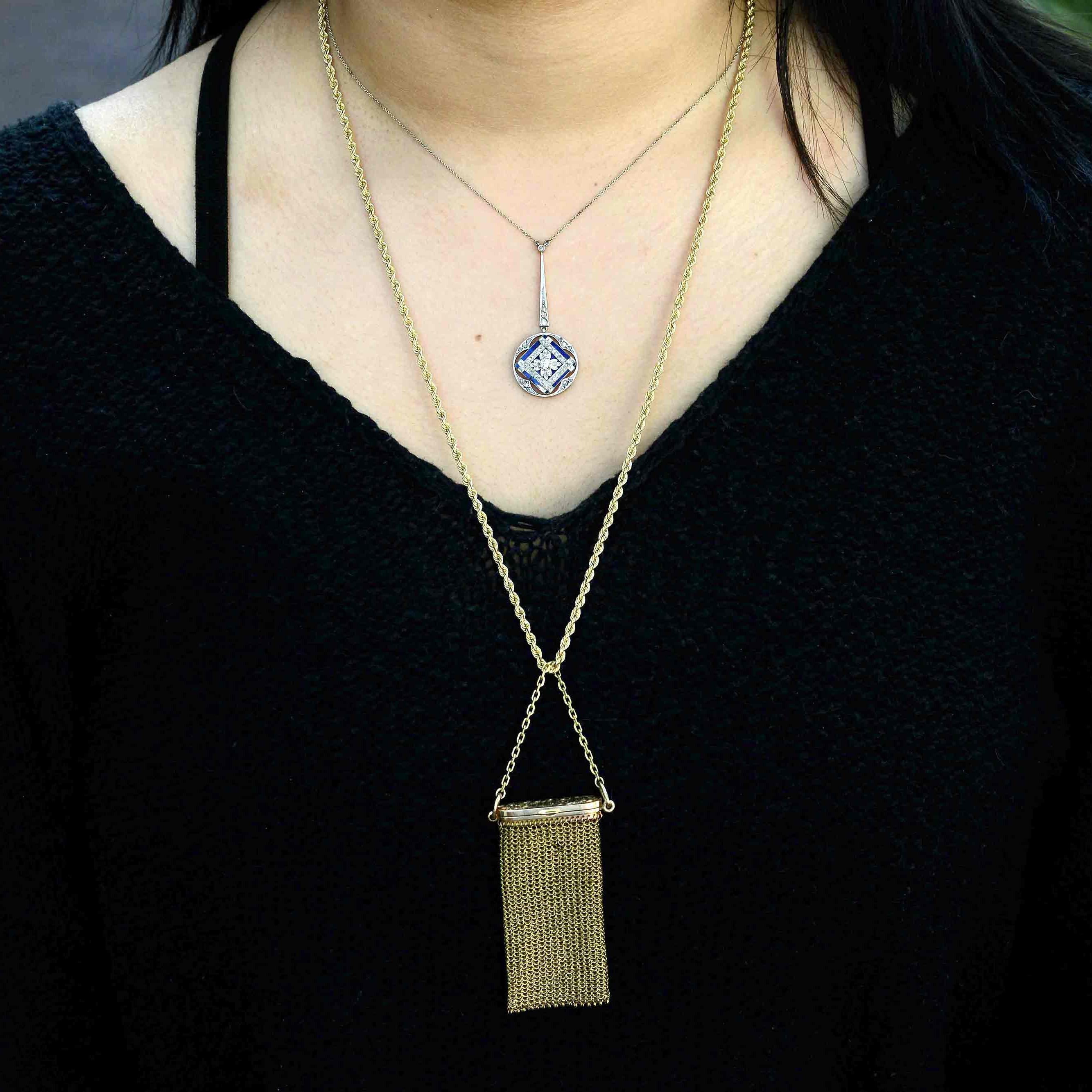 A platinum and yellow gold antique diamond pendant necklace.