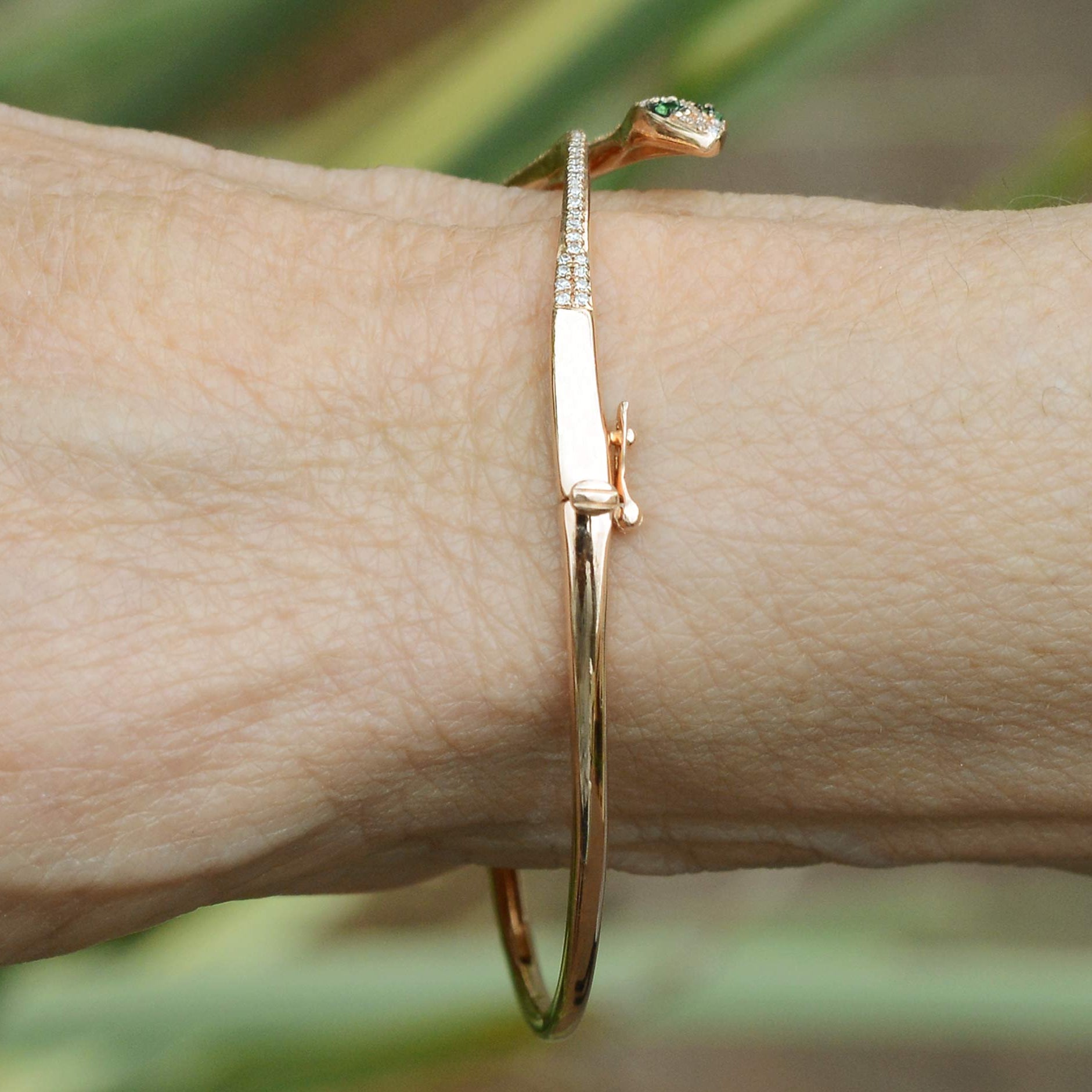 A rose gold egyptian revival snake bracelet.