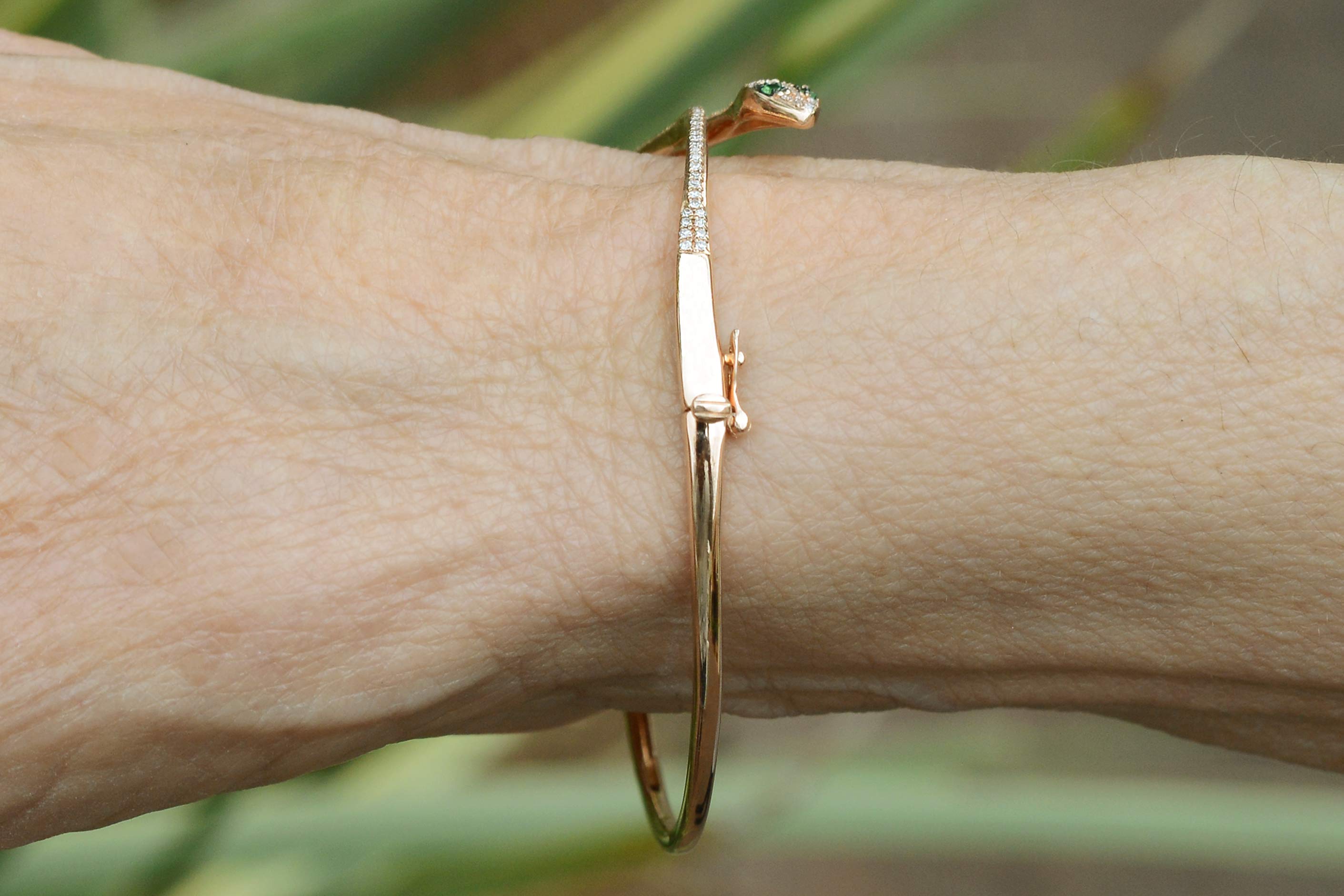 A rose gold egyptian revival snake bracelet.