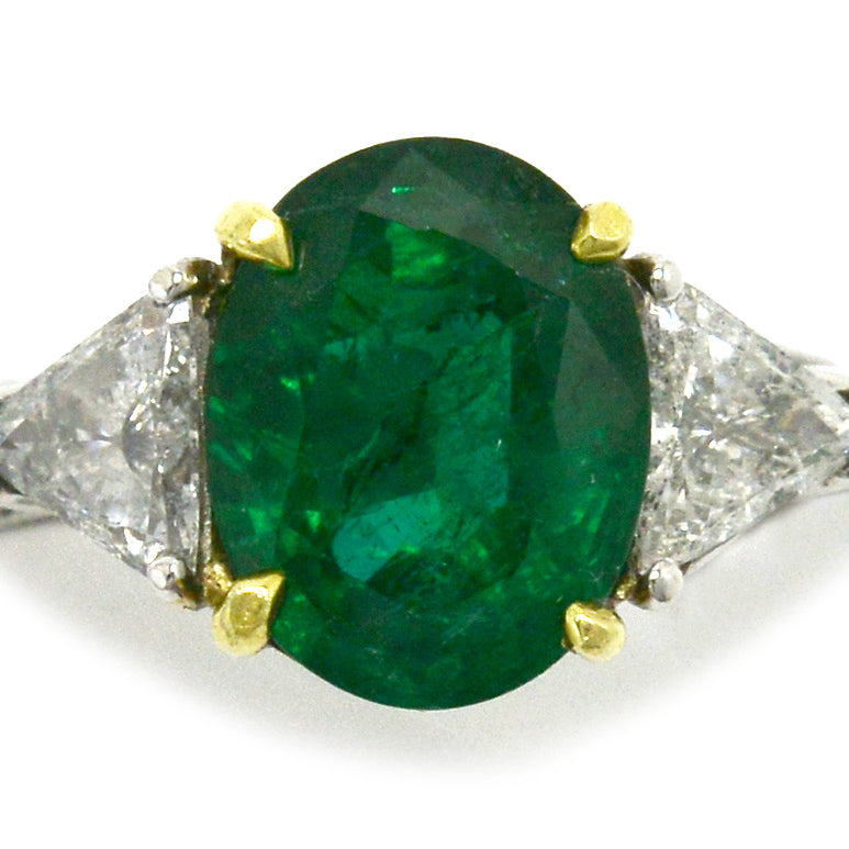 A 4 carat natural emerald and diamond trinity engagemement ring.