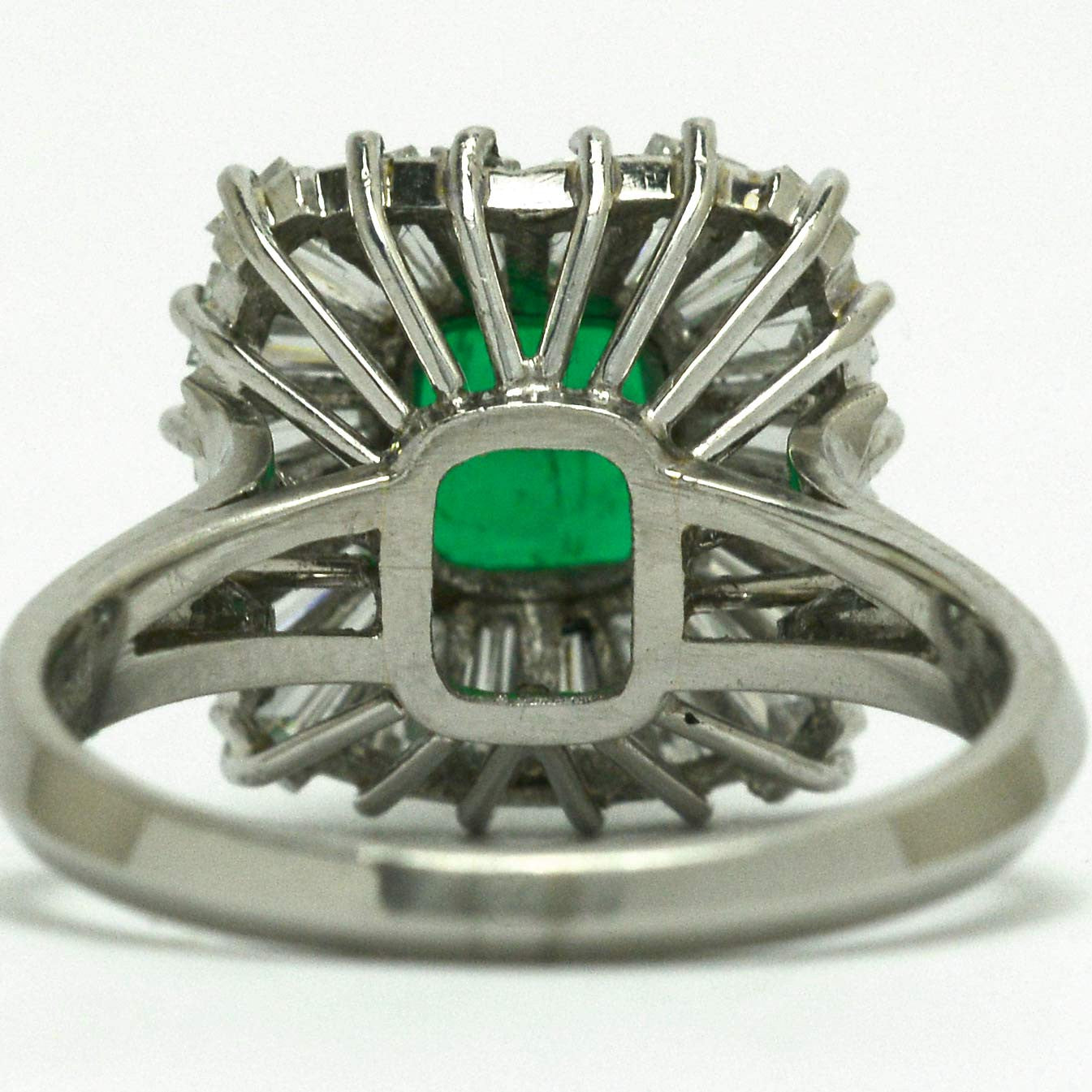 A mid century platinum emerald diamond geometric ballerina ring.