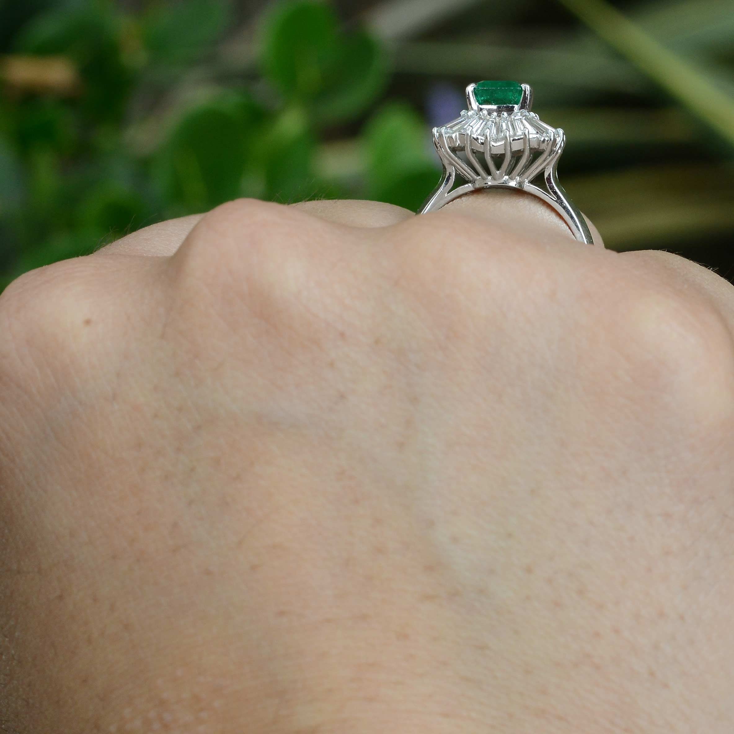 A mid century emerald ballerina ring, accented by a wavy design of diamonds.