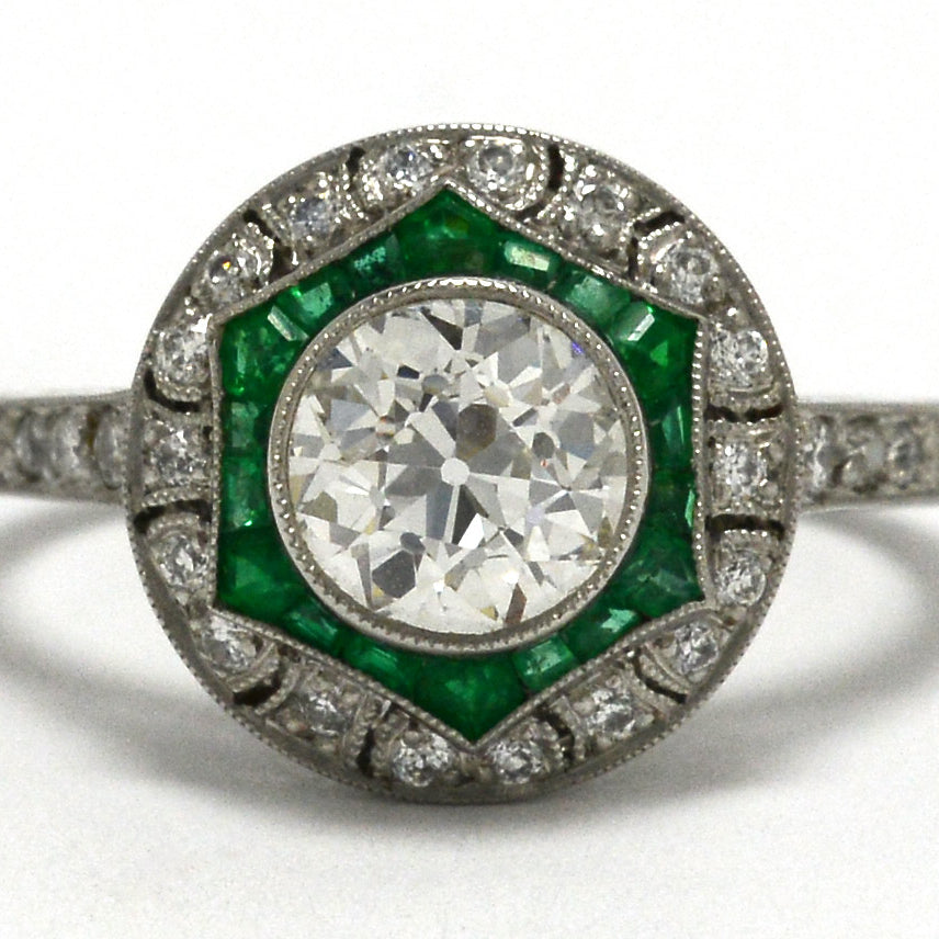 An old mine brilliant diamond, Art Deco style engagement ring with an emerald halo.