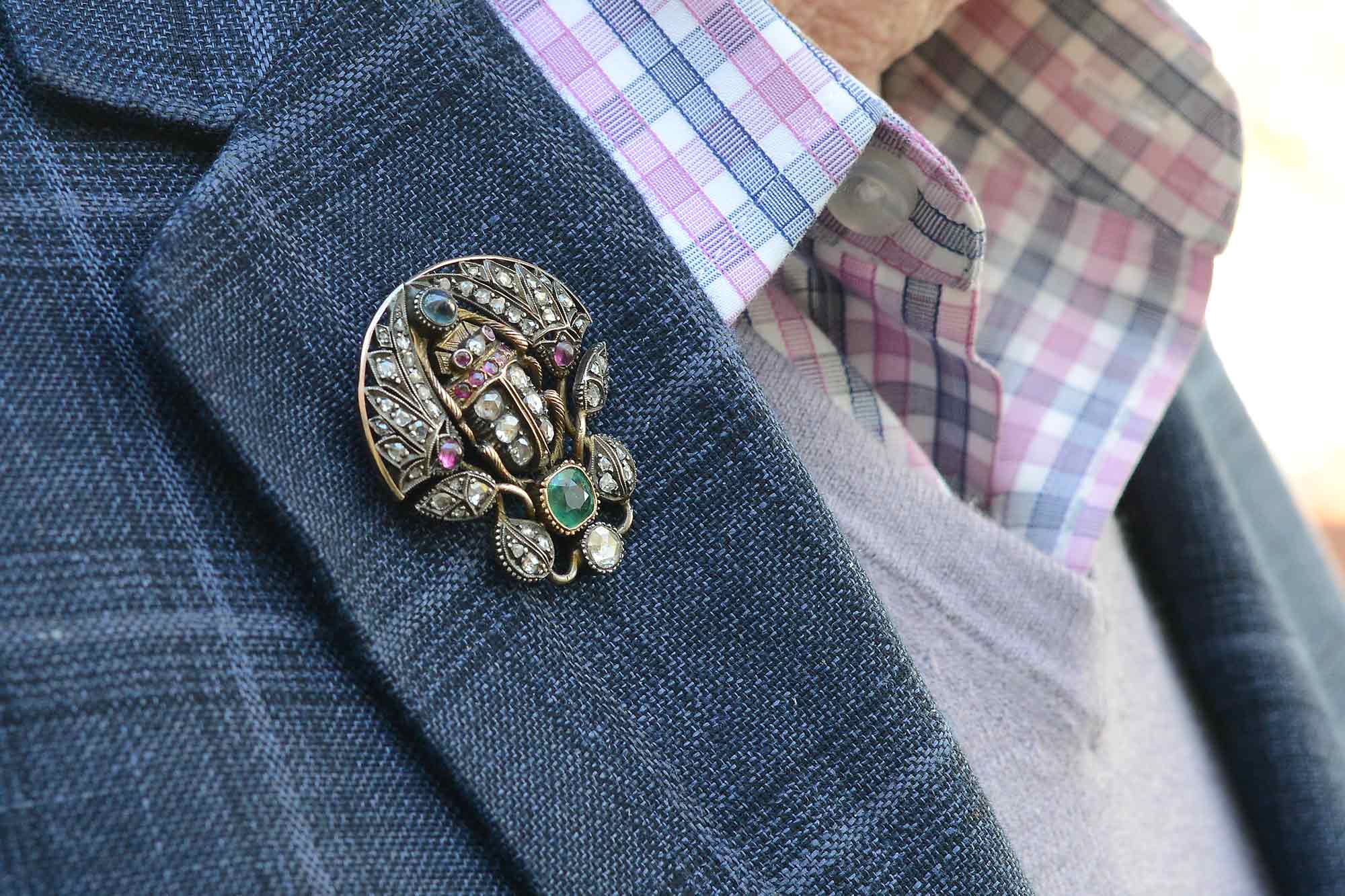 An antique, gold Victorian scarab beetle pin with a silver top.