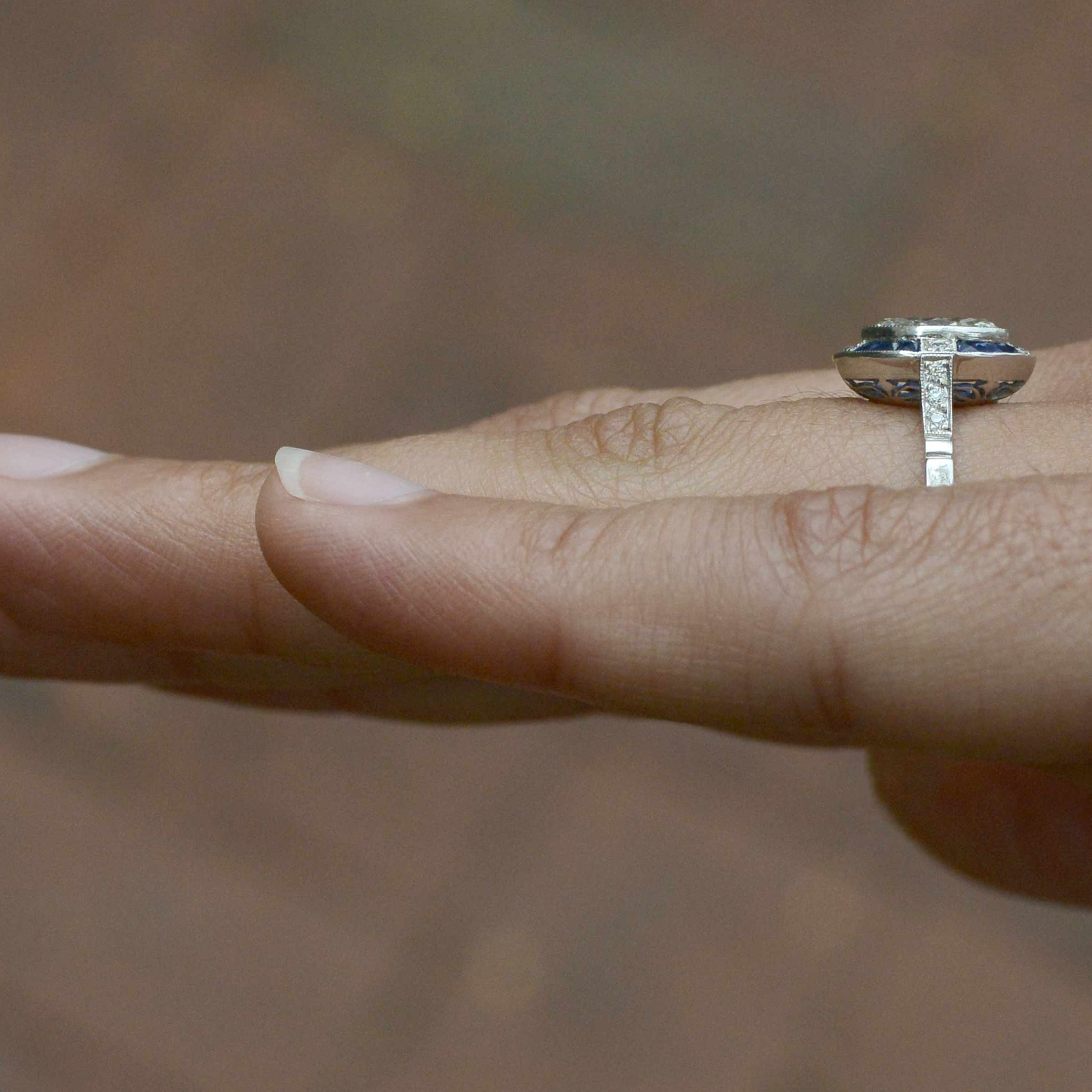 A diamond shank Art Deco engagement ring with blue sapphires.