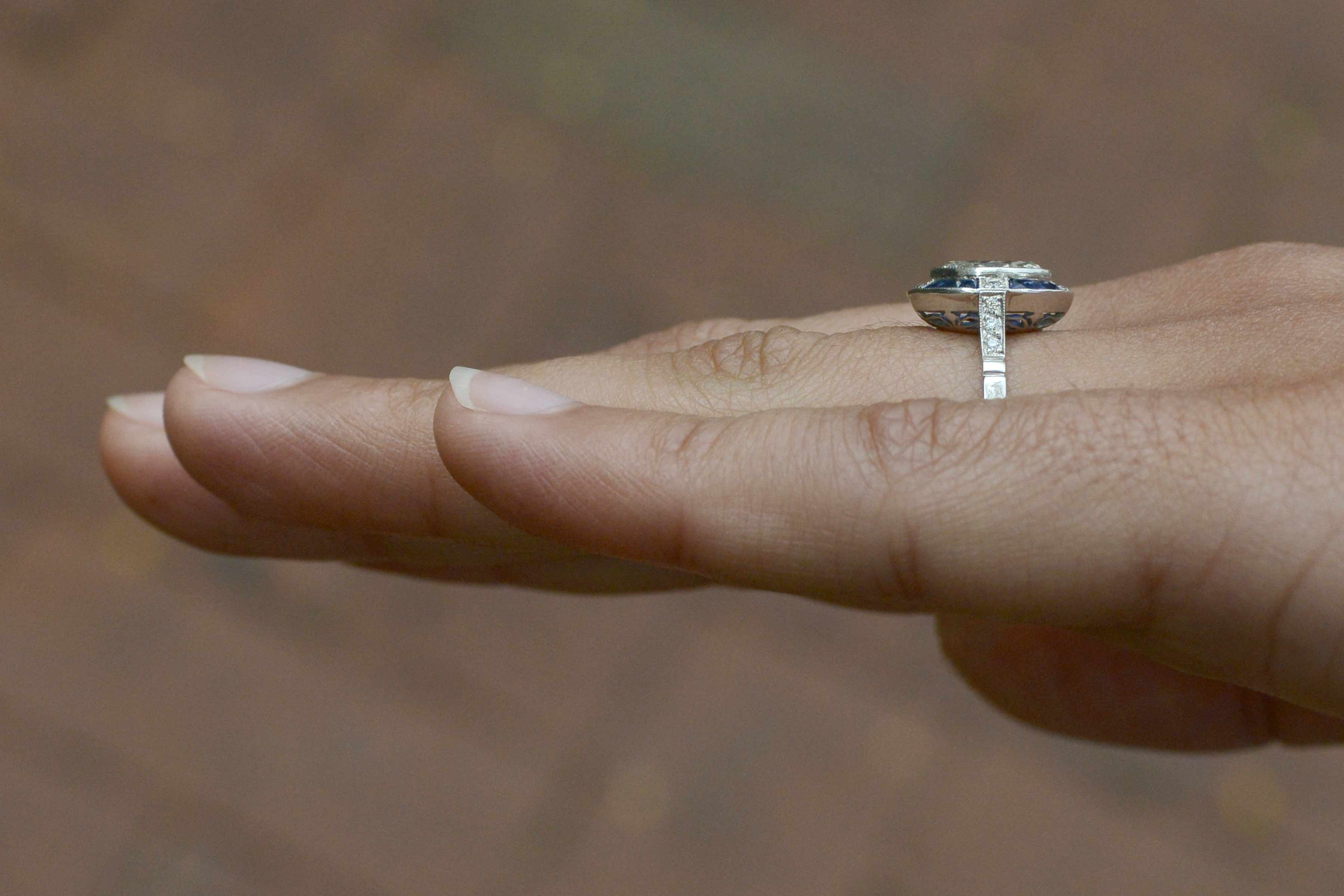 A diamond shank Art Deco engagement ring with blue sapphires.