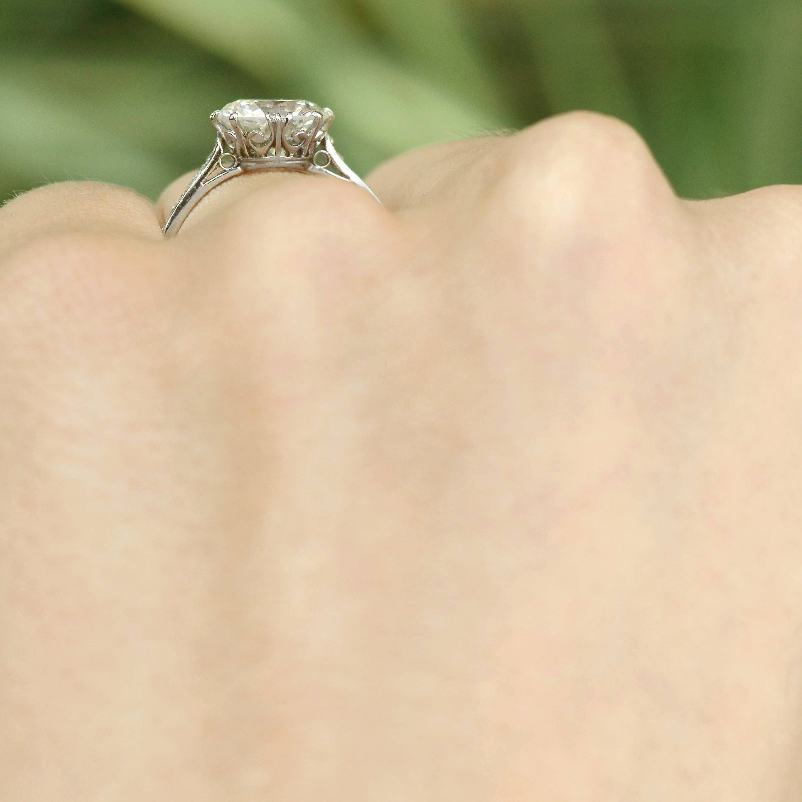 Filigree under gallery, large diamond solitaire with a fleur des lis design..