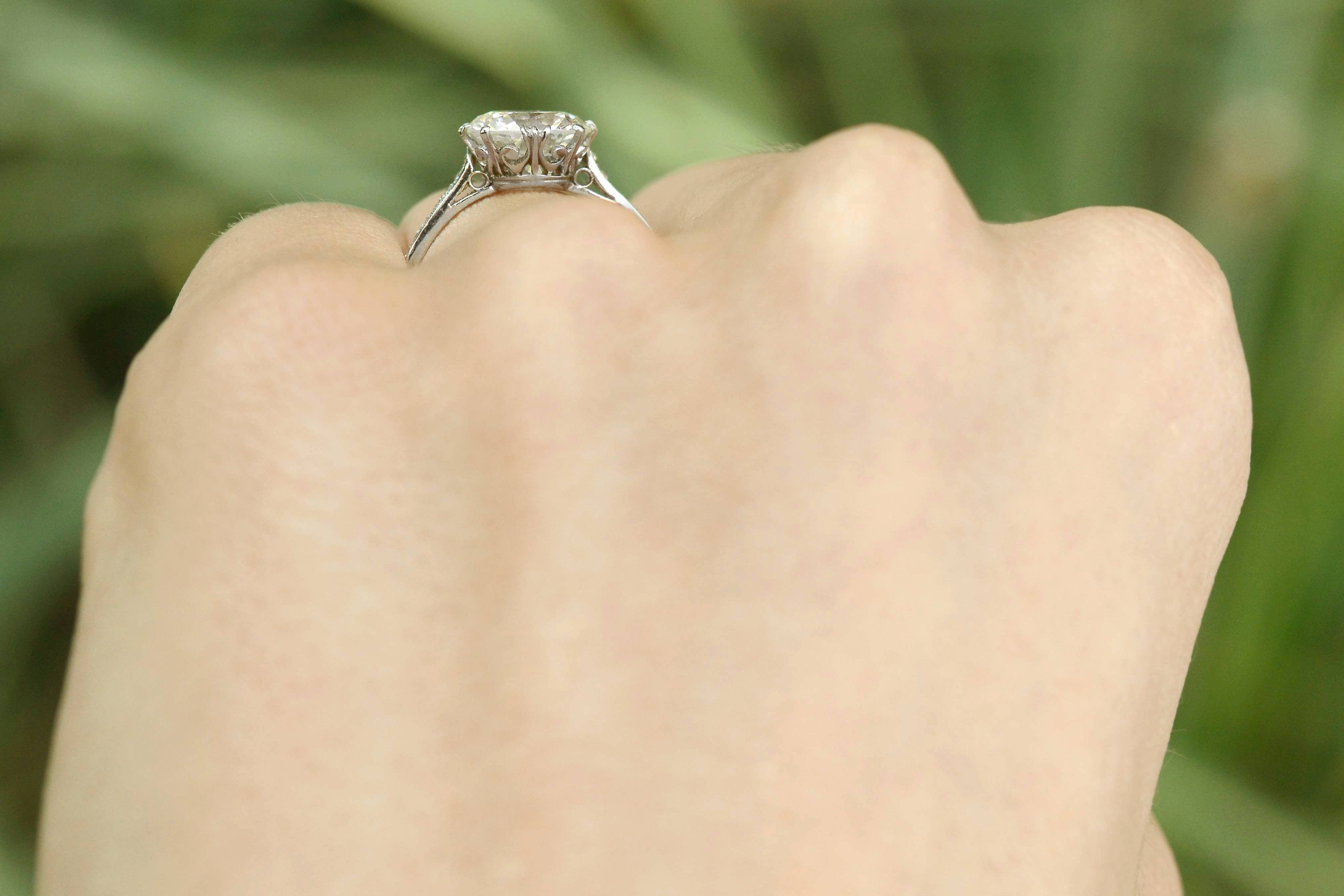 Filigree under gallery, large diamond solitaire with a fleur des lis design..