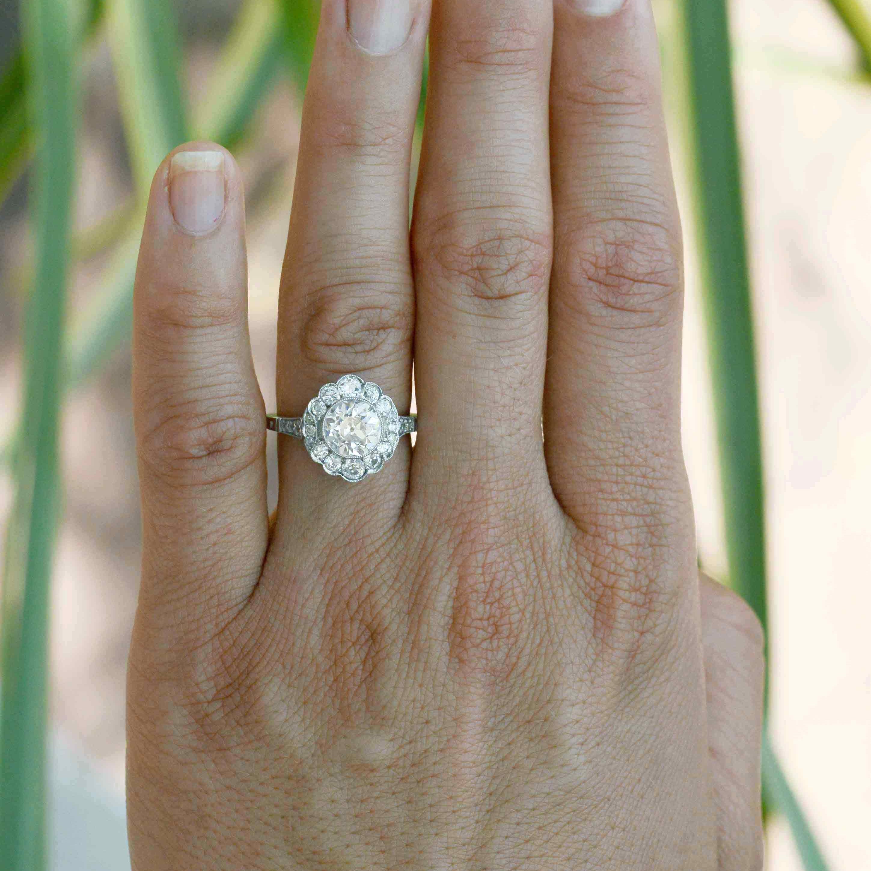 A flower shape diamonds halo engagement ring.