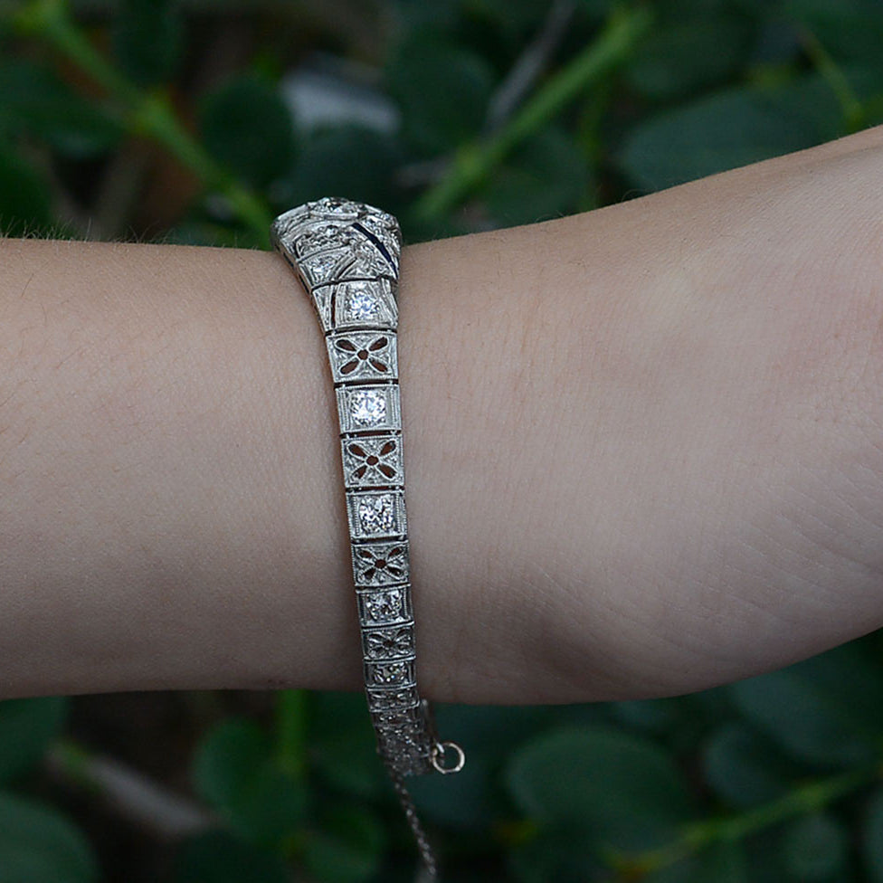 Floral filigree accents are on the sides of this Art Deco diamonds bracelet.