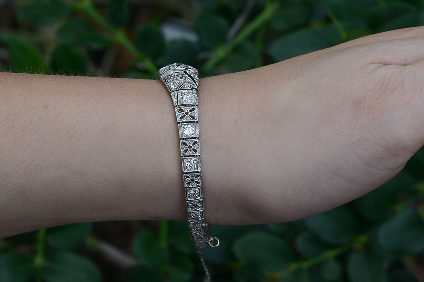 Floral filigree accents are on the sides of this Art Deco diamonds bracelet.