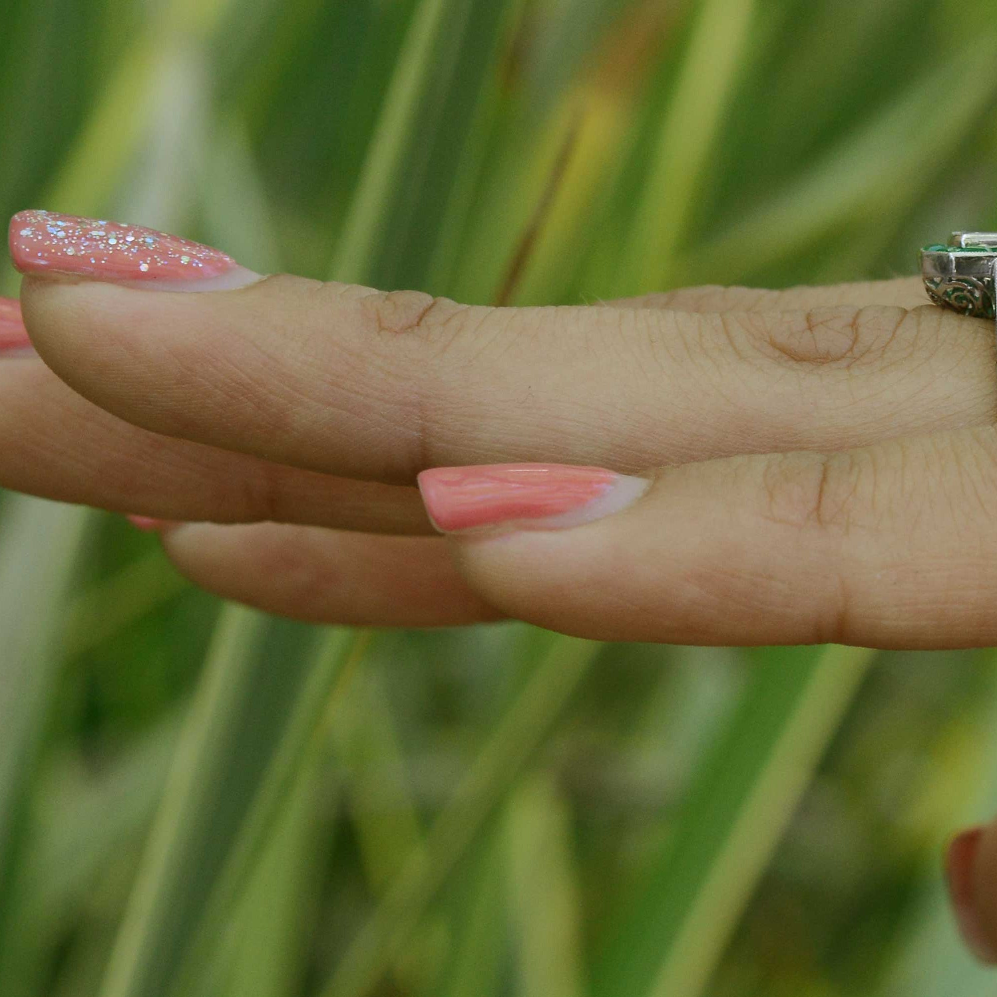 This Art Deco revival engagement ring has diamonds on the shoulder of the band.