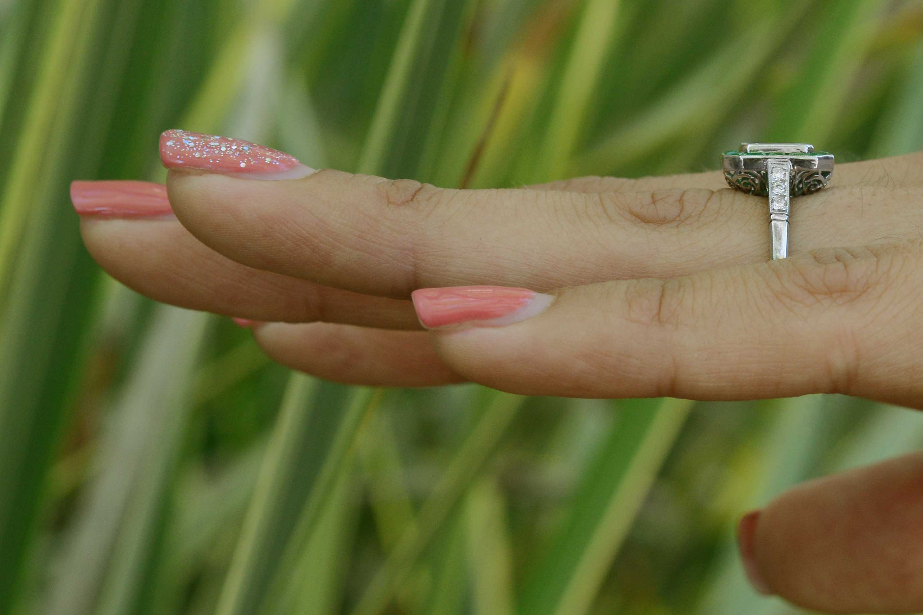 This Art Deco revival engagement ring has diamonds on the shoulder of the band.