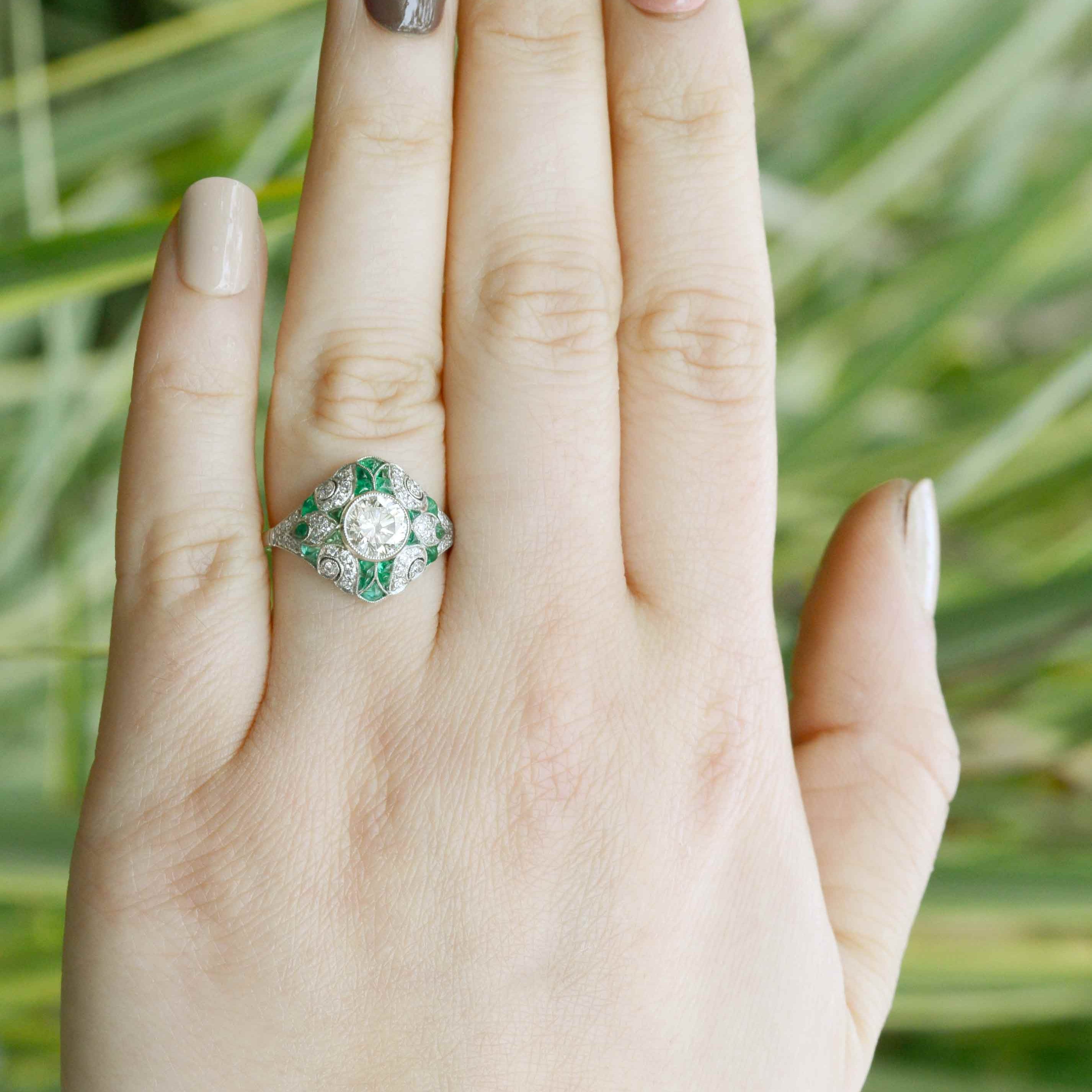 An N color with Vs2 clarity diamond is set in this stunning emerald ring.