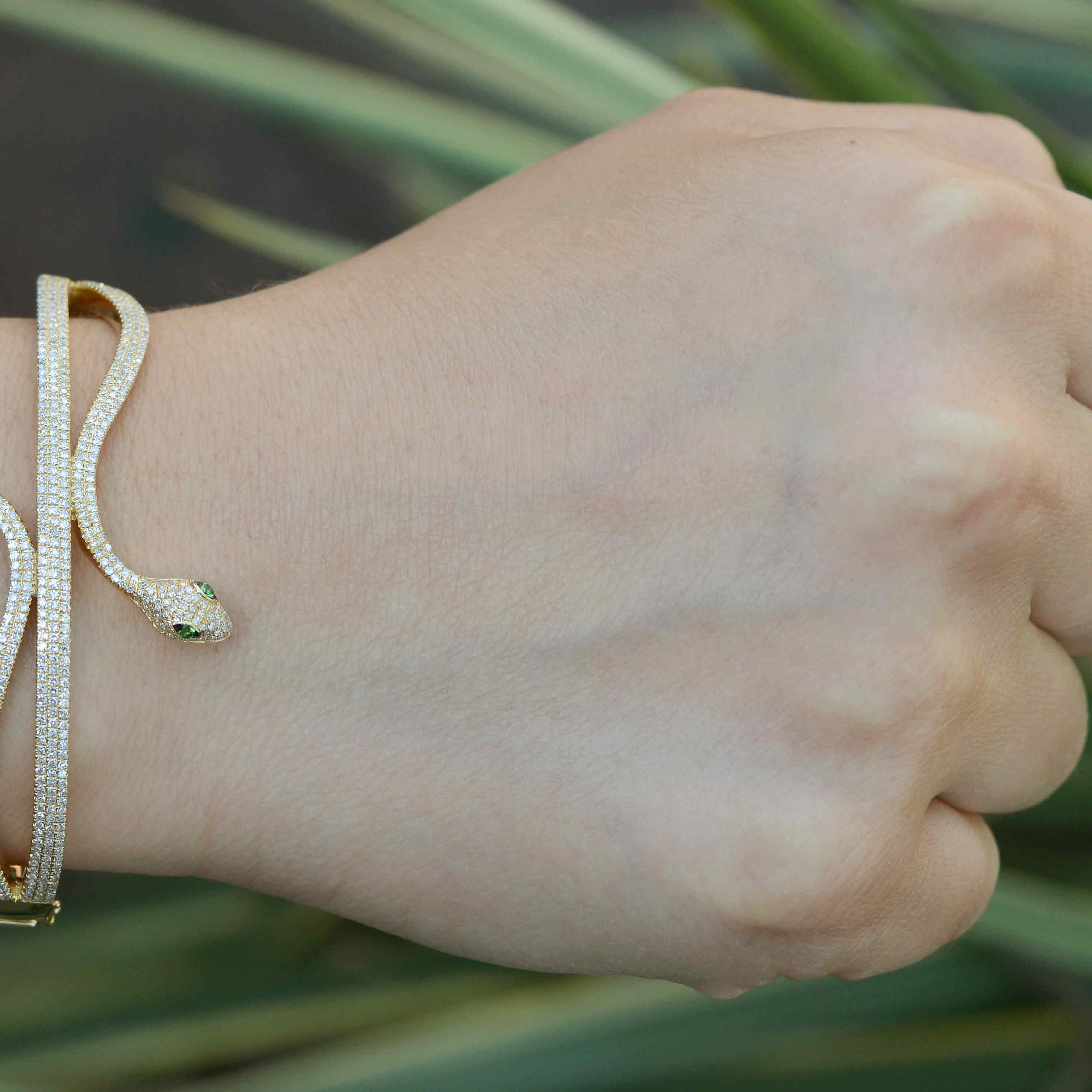 A gold Egyptian revival bracelet styled as a serpent bangle.