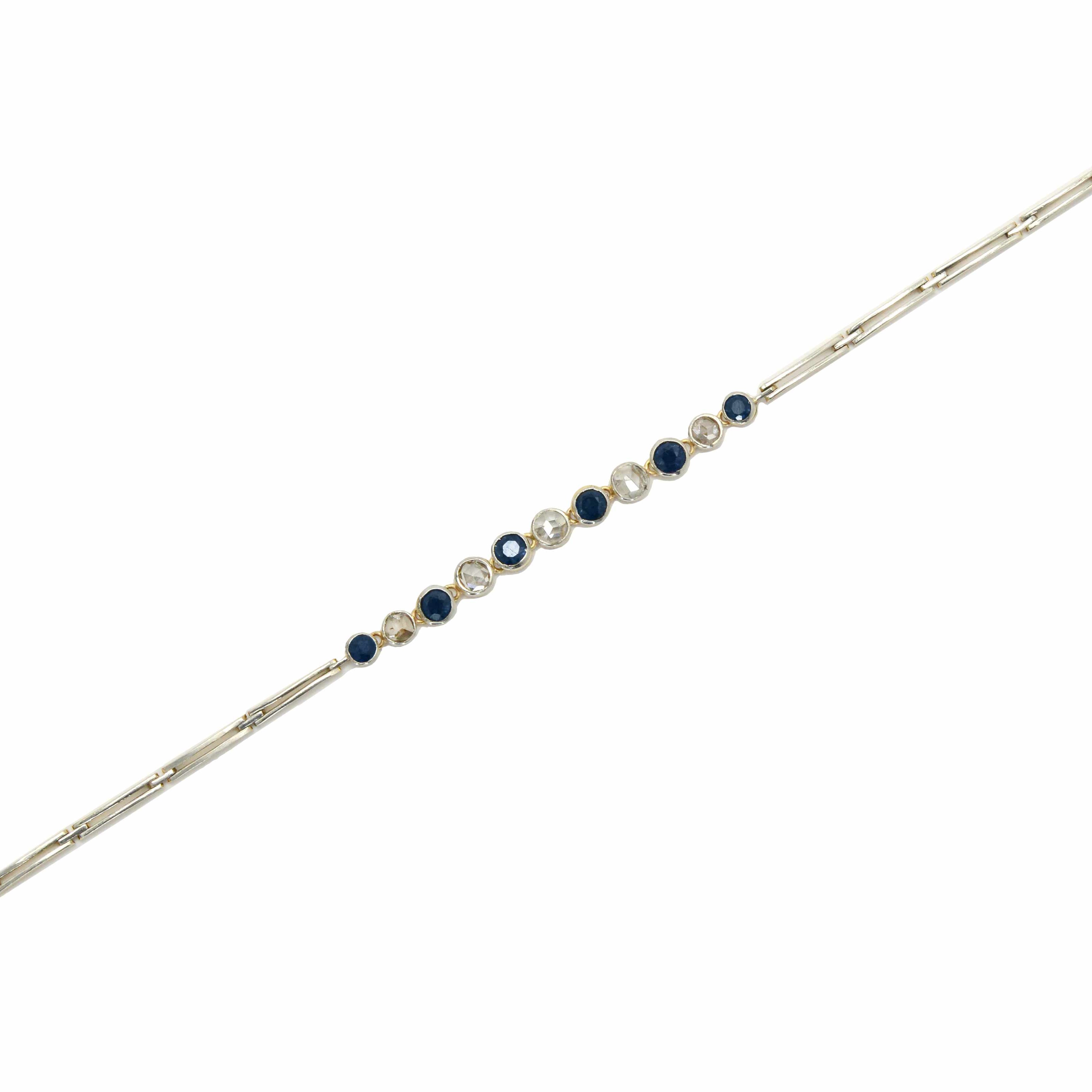 A 2 tone antique link bracelet with blue sapphires and diamonds.