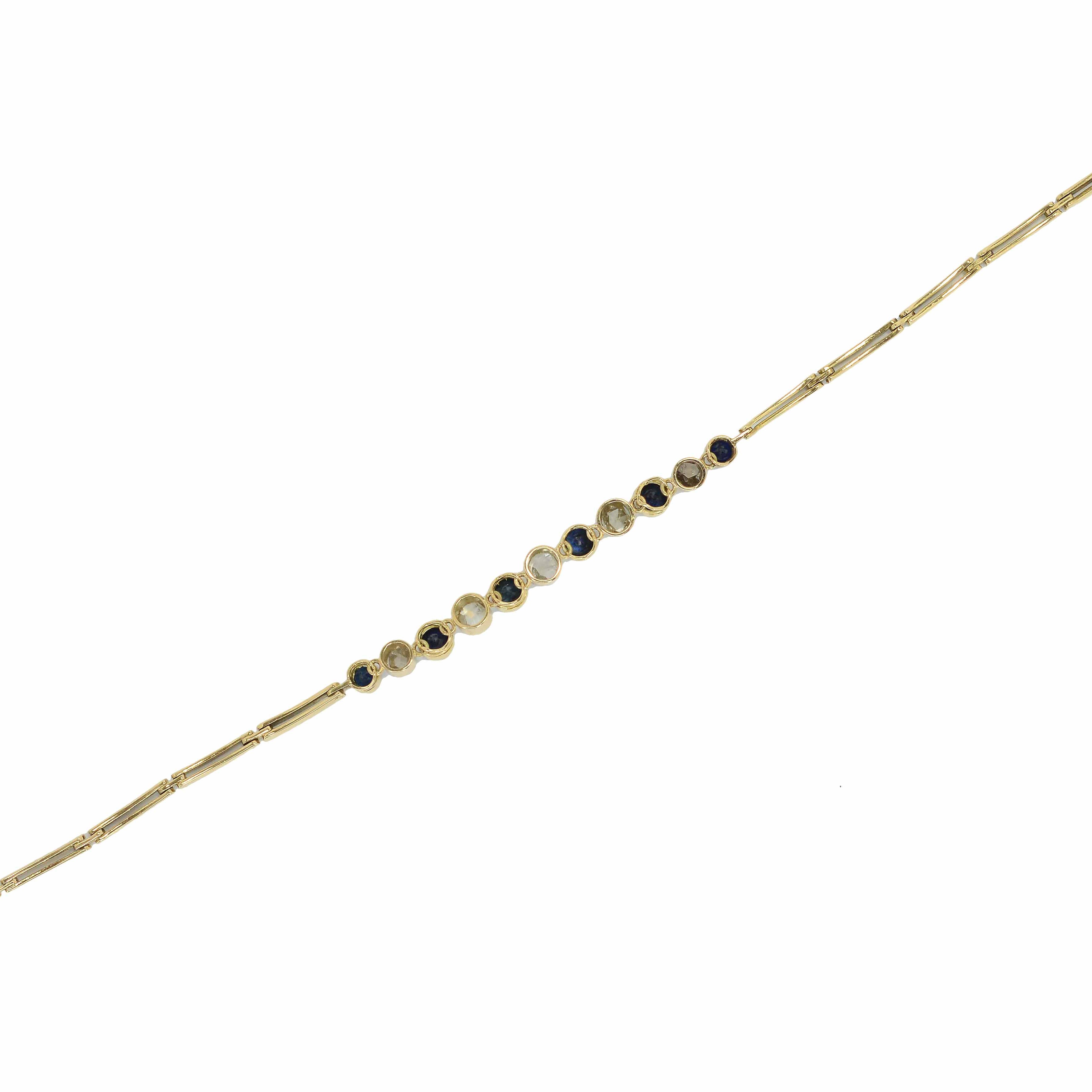 A stunning two tone gold and platinum bracelet holding blue sapphires and diamonds.