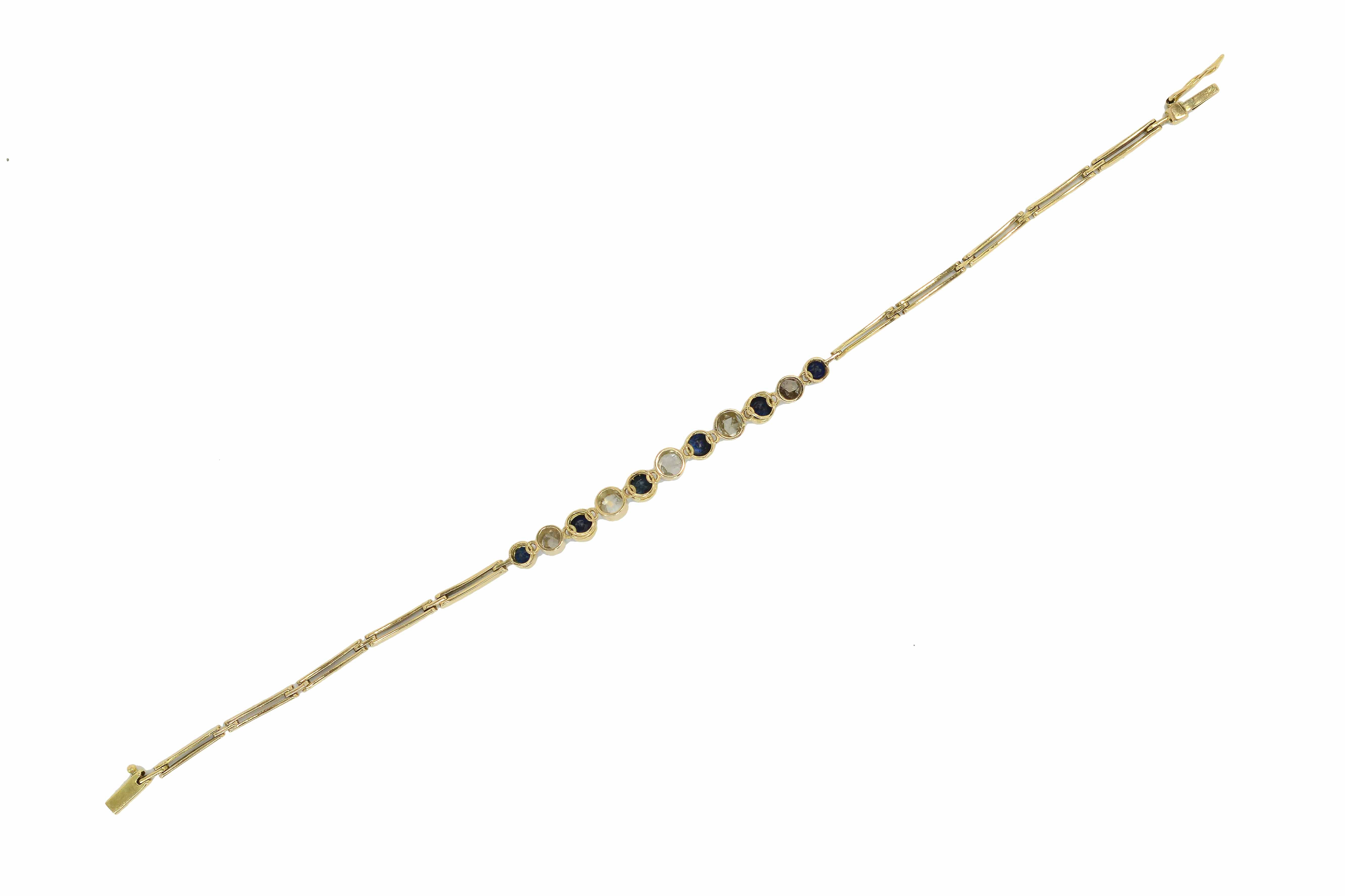 A stunning two tone gold and platinum bracelet holding blue sapphires and diamonds.