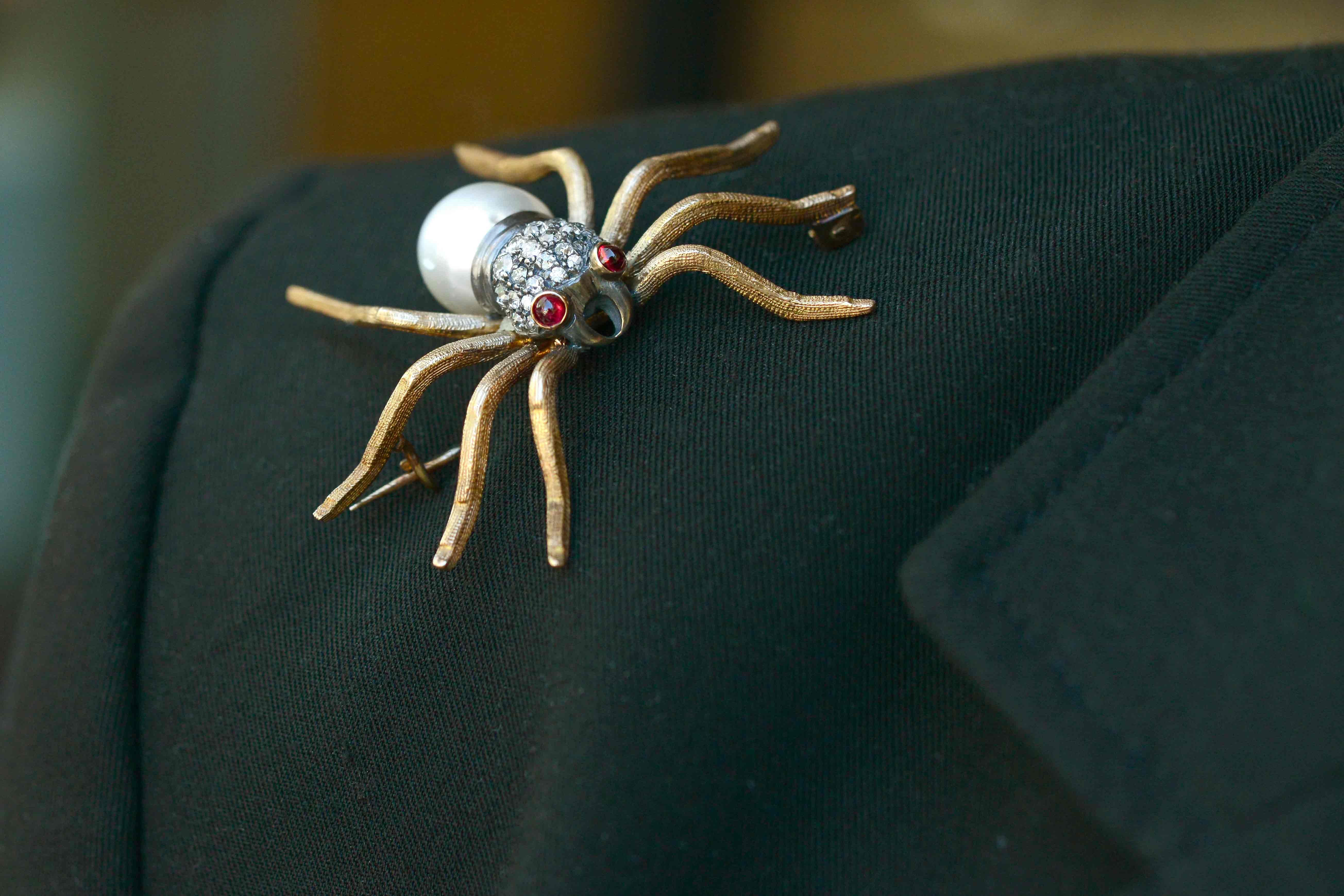 An antique gold spider brooch pin.