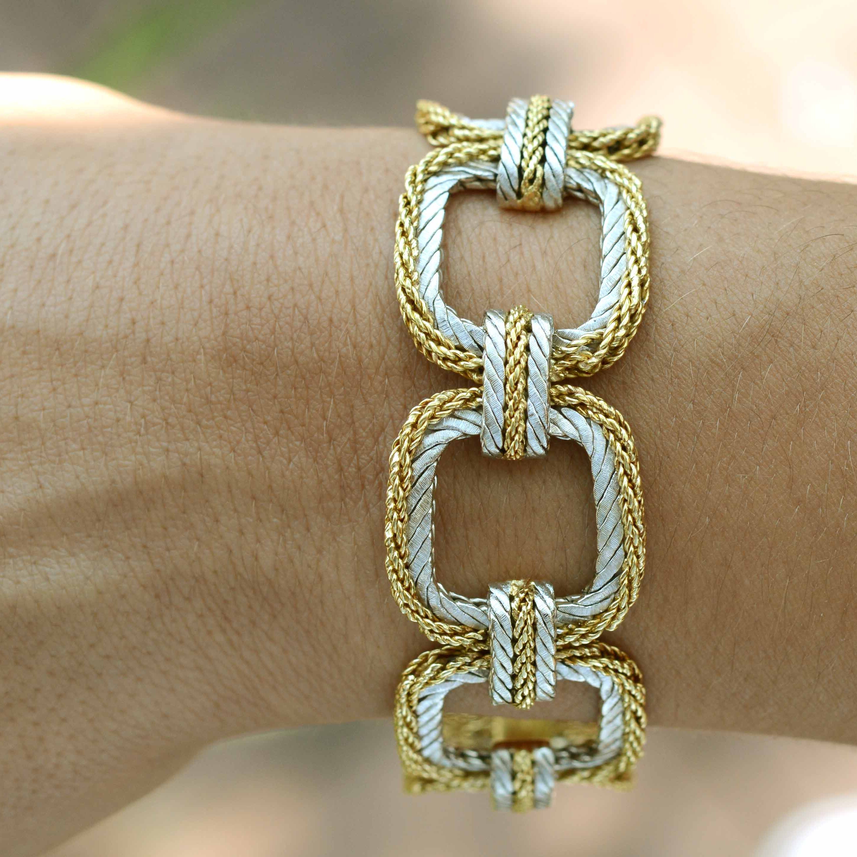 A designer square link bracelet made from white and yellow gold.