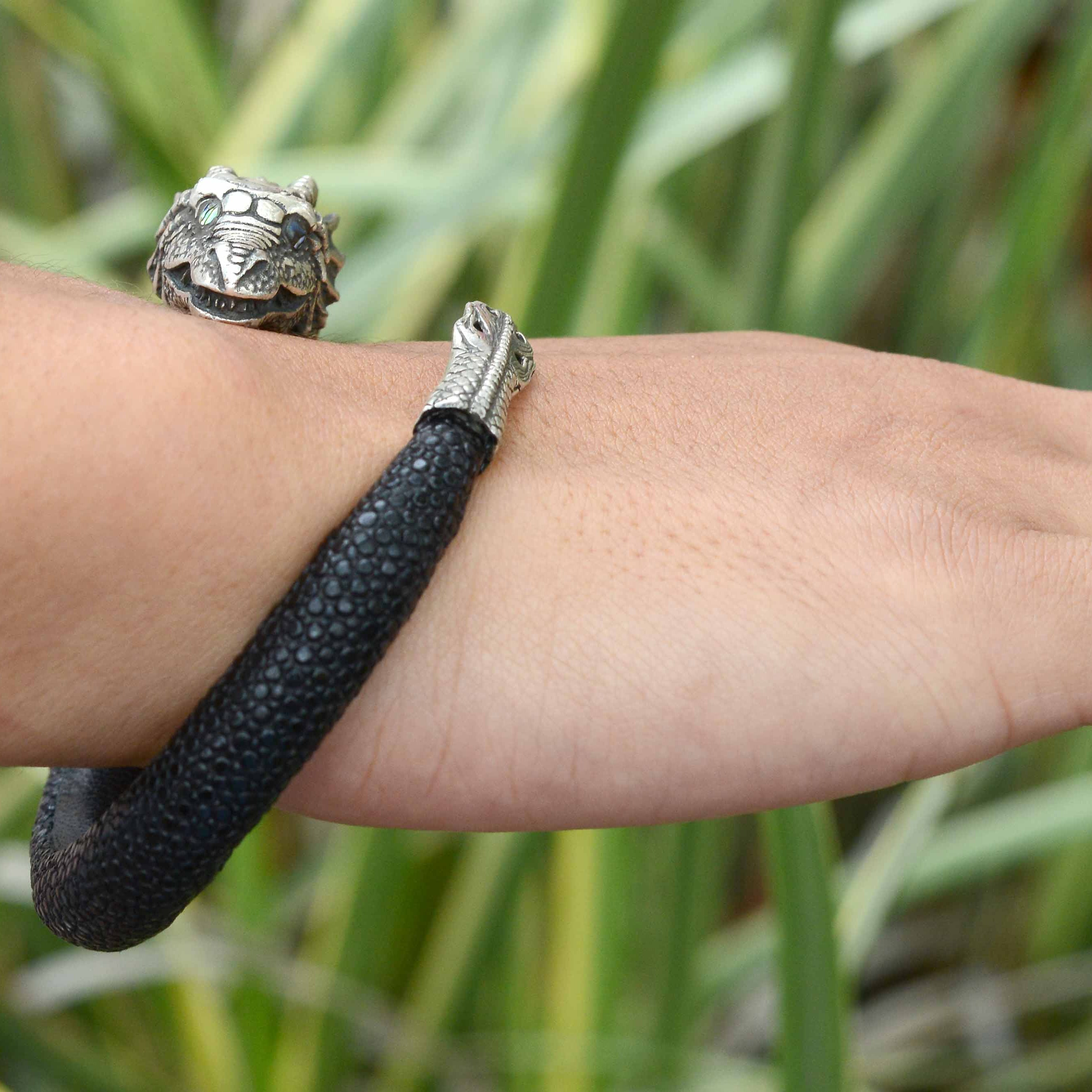 A gothic revival vibe silver dragon bracelet wraps your arm.