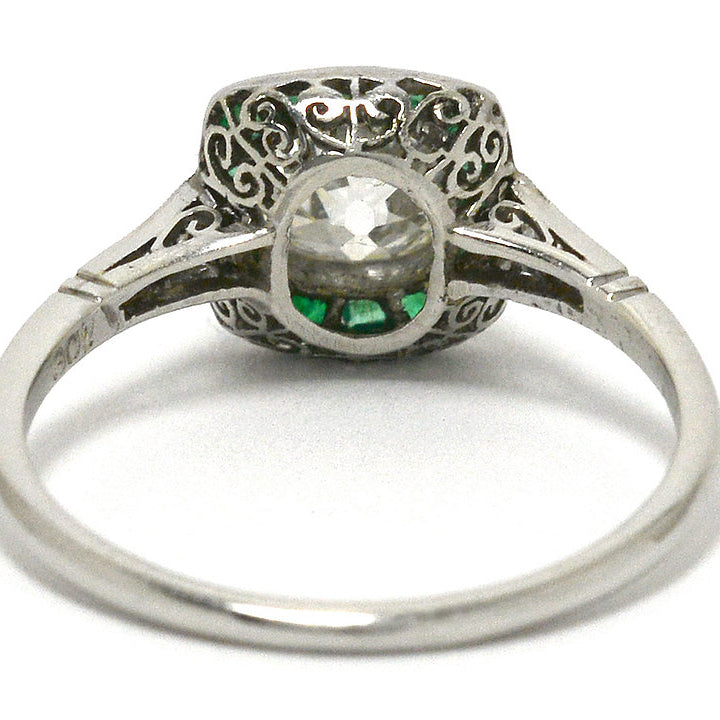 The bottom of this antique Art Deco solitaire with emeralds.