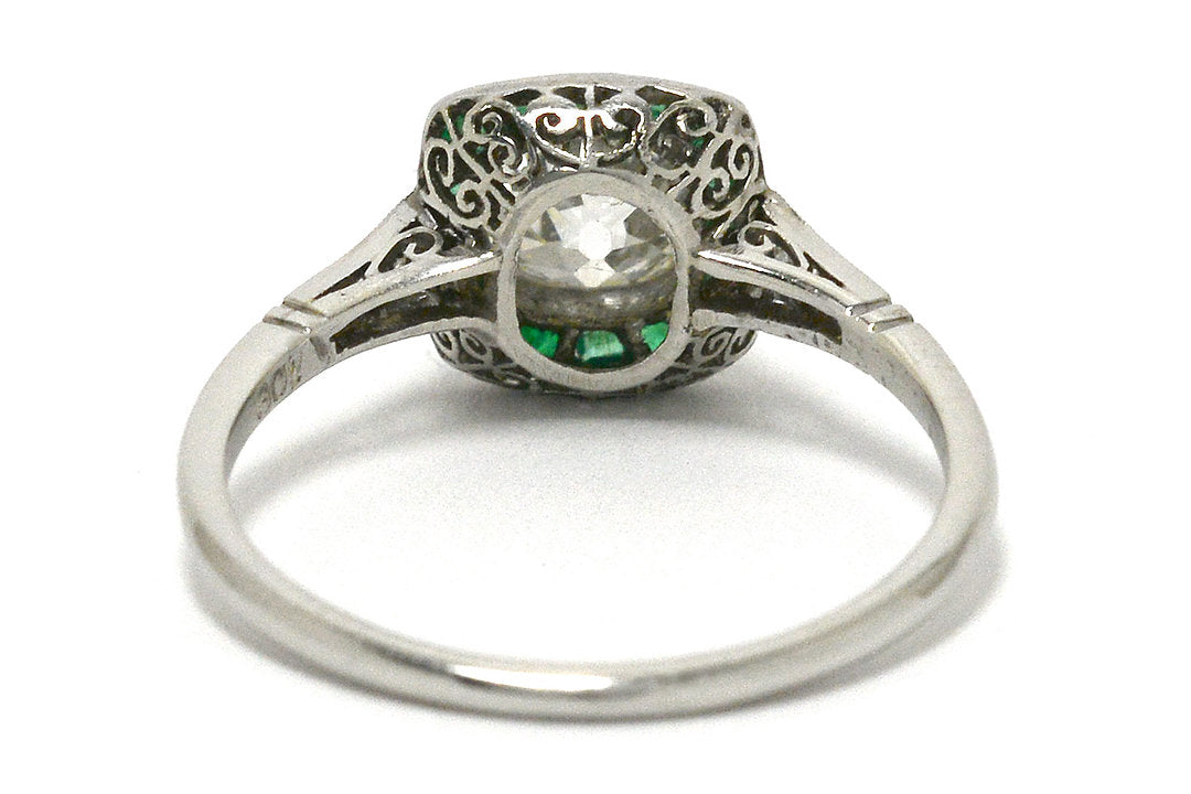 The bottom of this antique Art Deco solitaire with emeralds.
