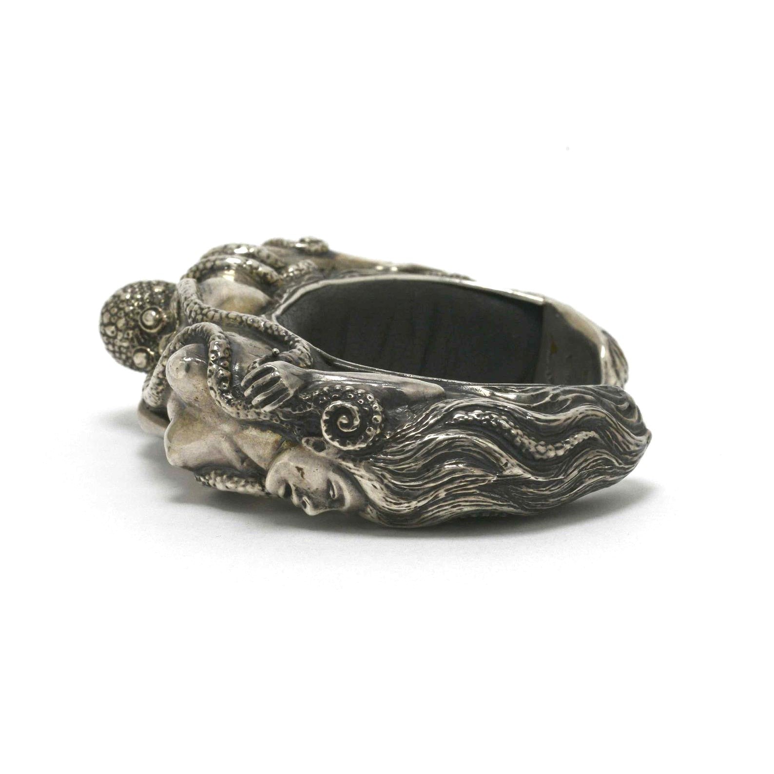 These are hand crafted silver and black leather cuffs by french artisan Lou.