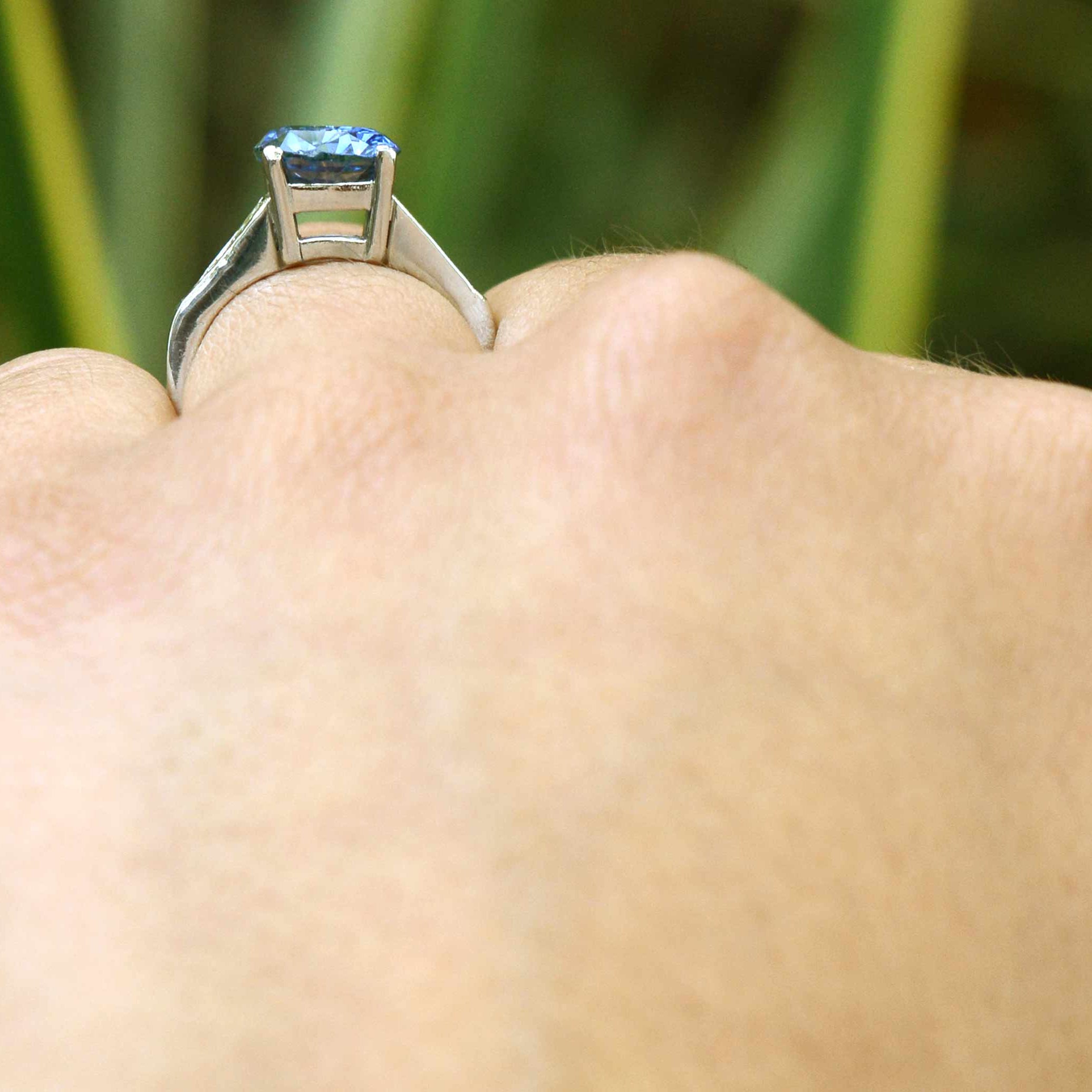 A platinum staircase mount Ceylon sapphire engagement ring.
