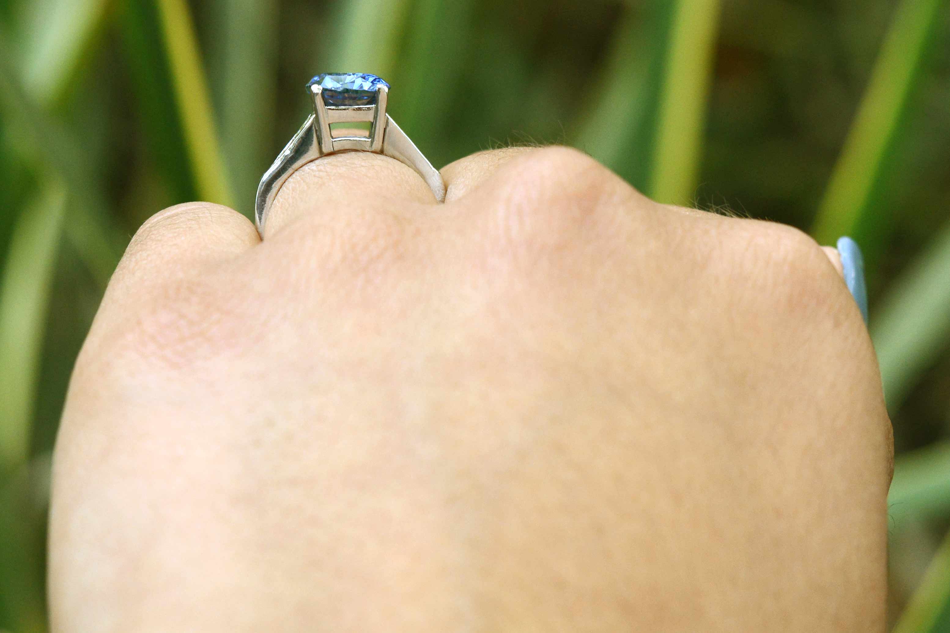 A platinum staircase mount Ceylon sapphire engagement ring.