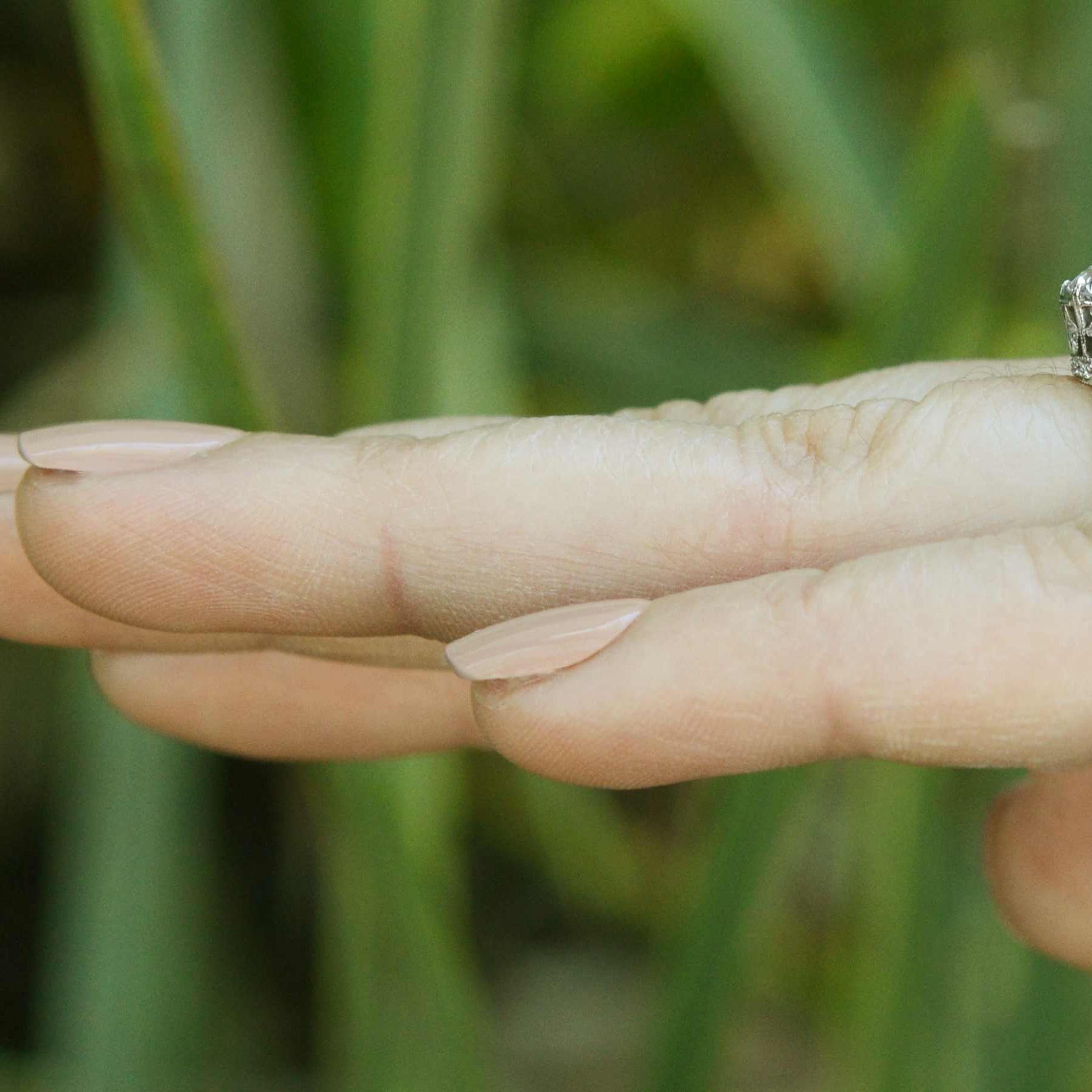 The 1 carat old european diamond in this revival engagement ring has large facets.