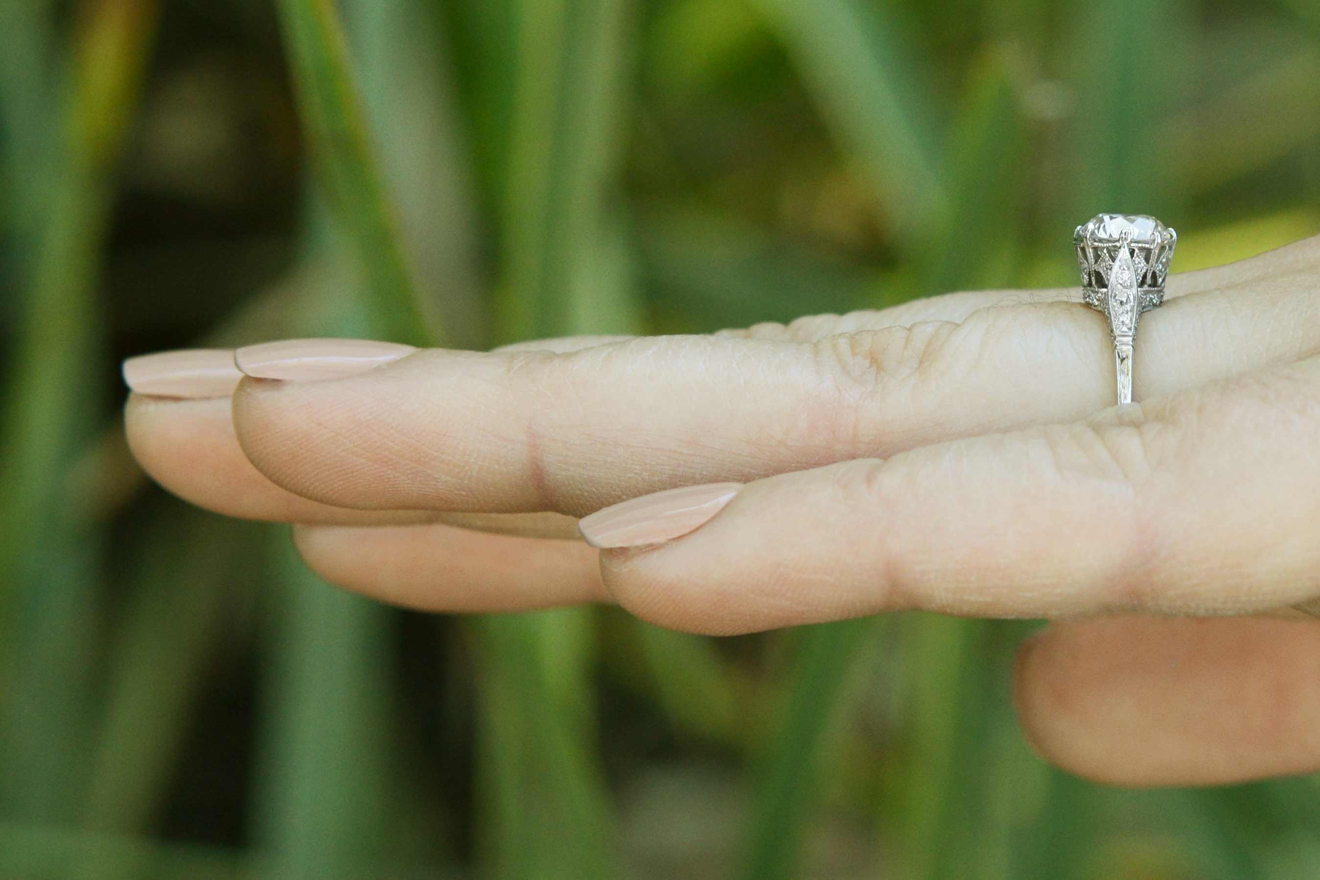 The 1 carat old european diamond in this revival engagement ring has large facets.