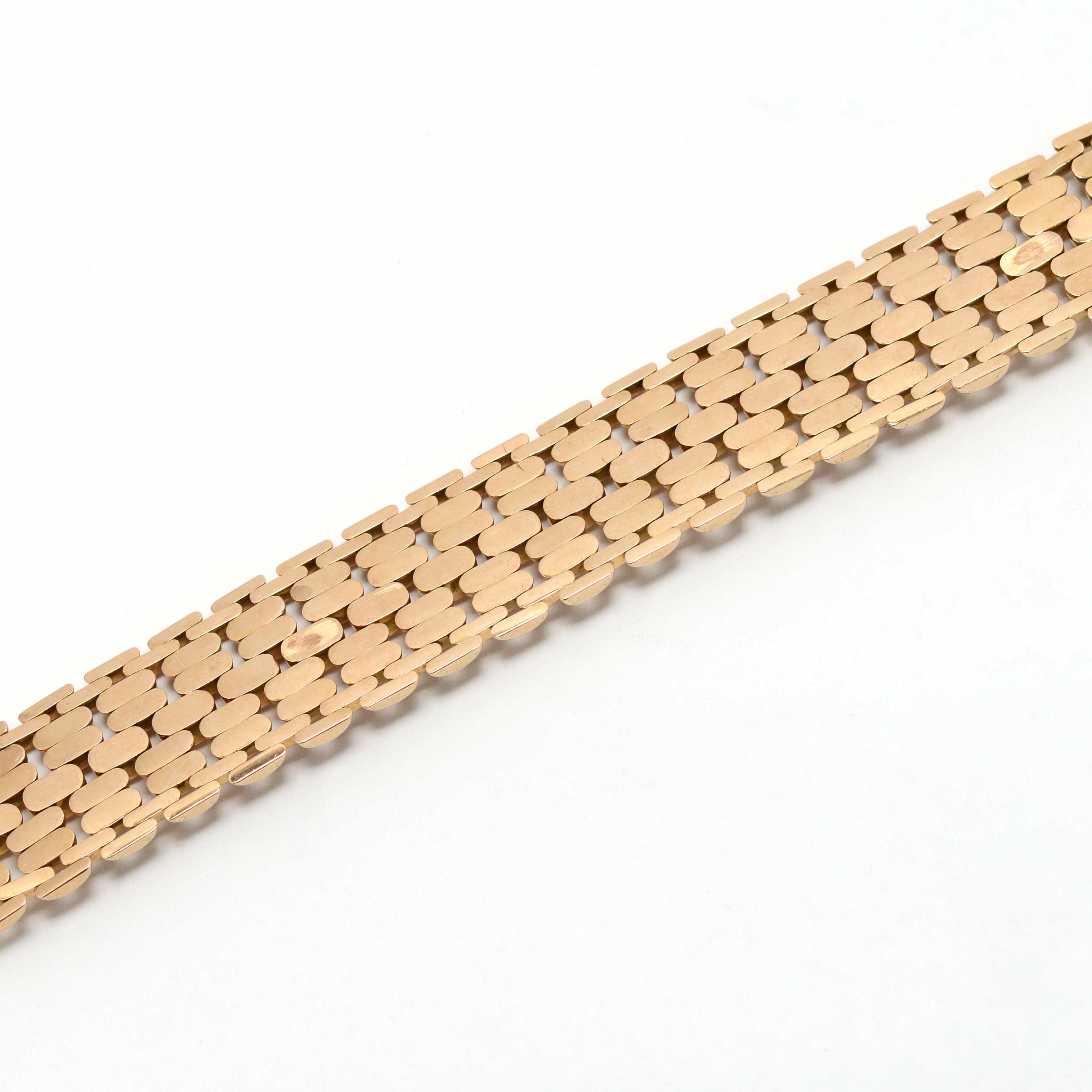 The underside of an industrial design gold bracelet.