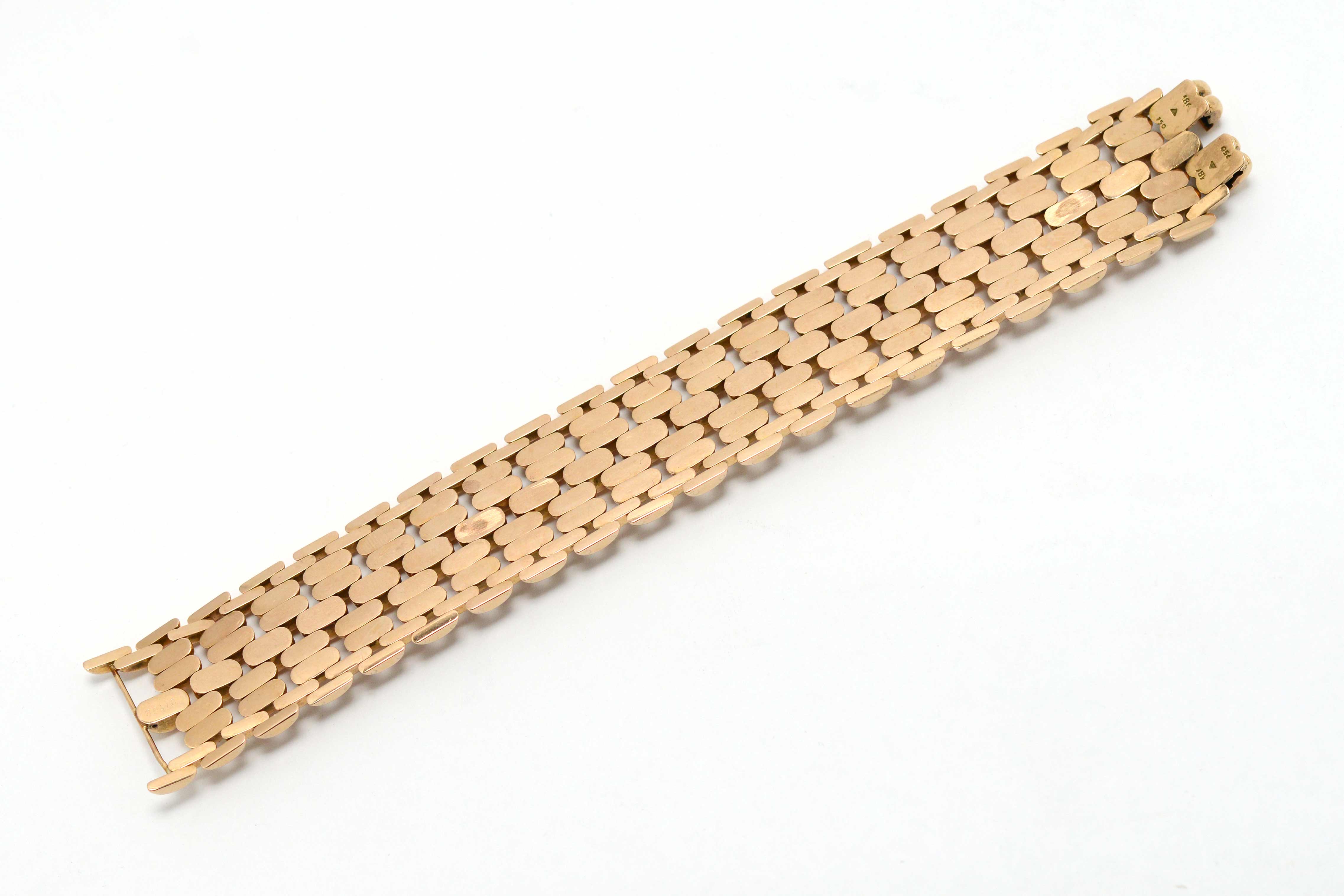 The underside of an industrial design gold bracelet.