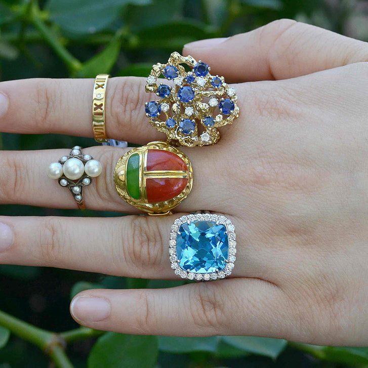 A collection of large, unique gemstone cocktail rings.