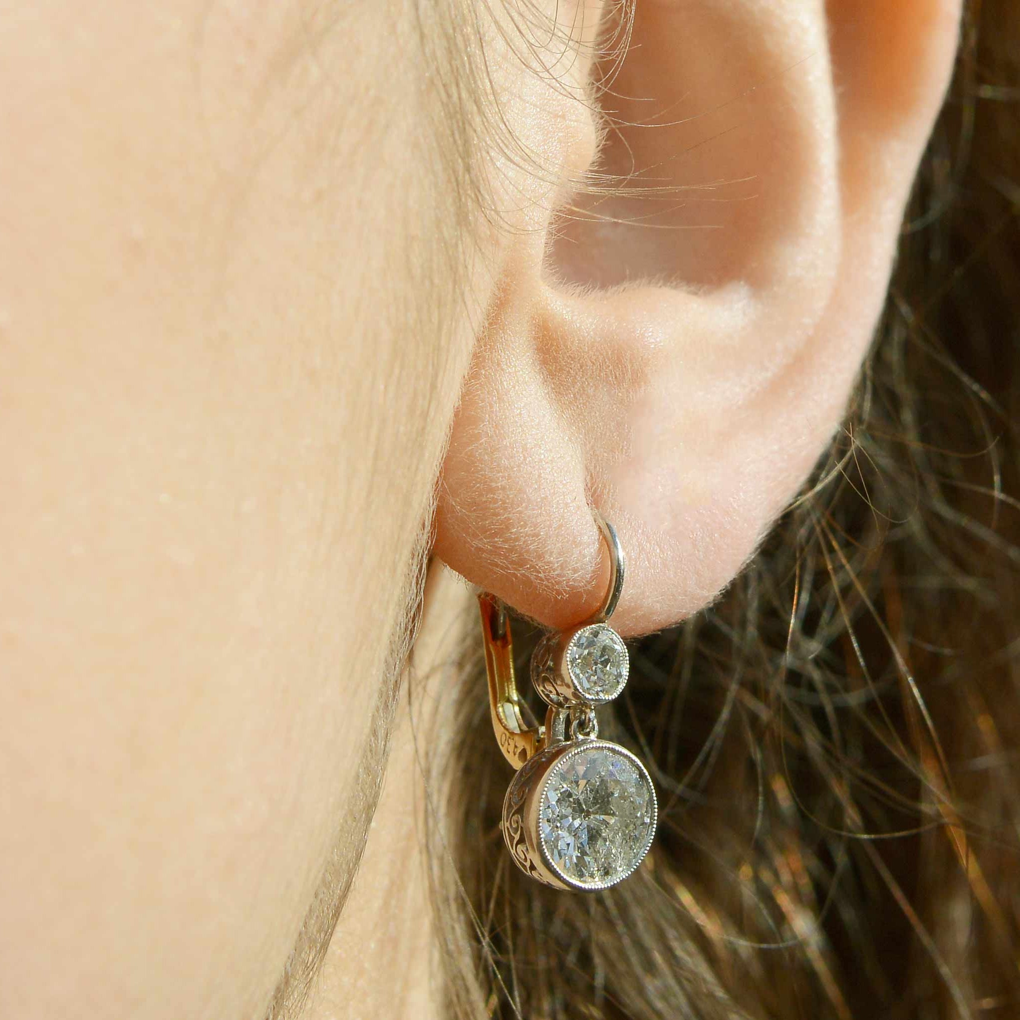 Platinum and 18k yellow gold leverback earrings with 4.30 carats of diamonds.