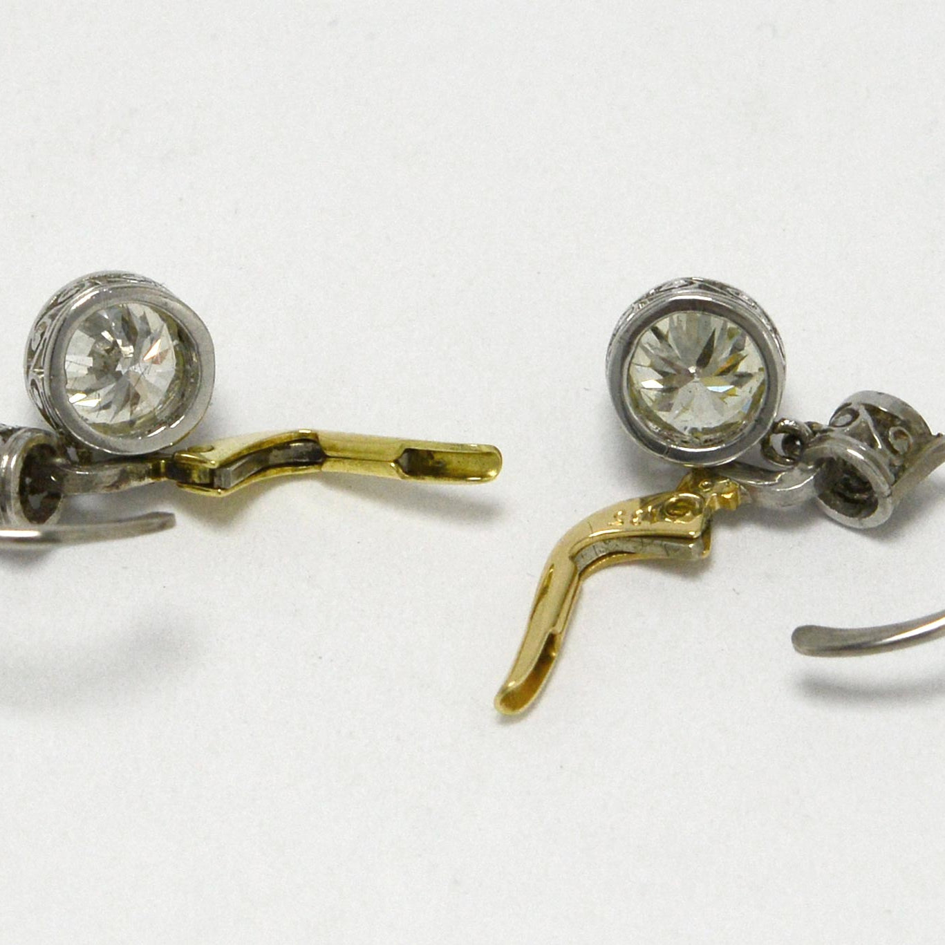 Platinum and 18k gold lever diamond vintage earrings.