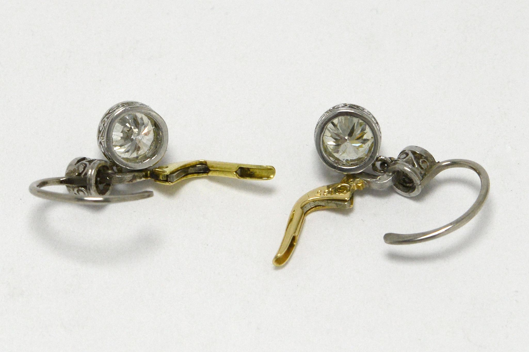 Platinum and 18k gold lever diamond vintage earrings.