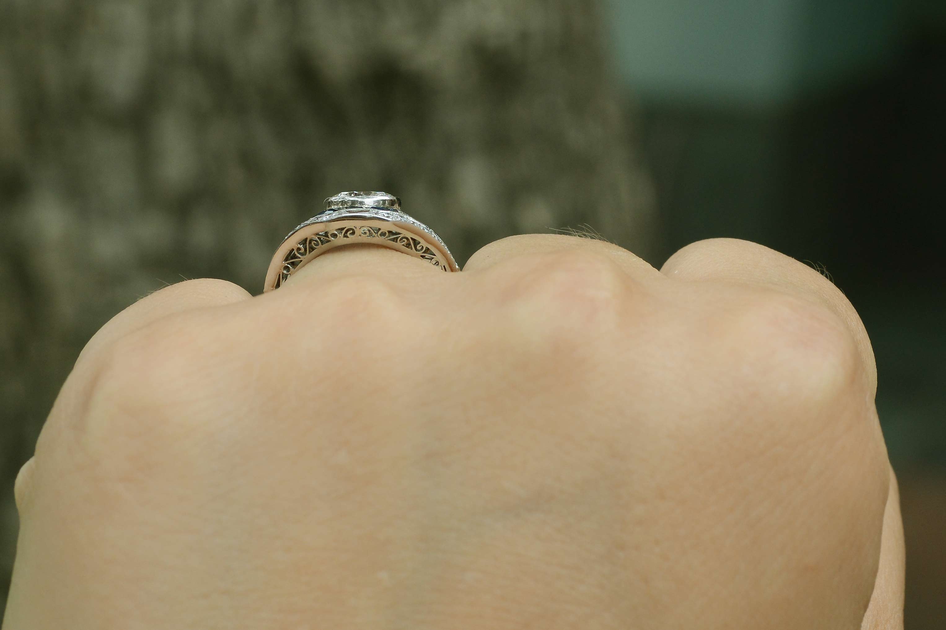 The 1 carat round cut diamond is in a bezel setting that won't snag on your clothes.