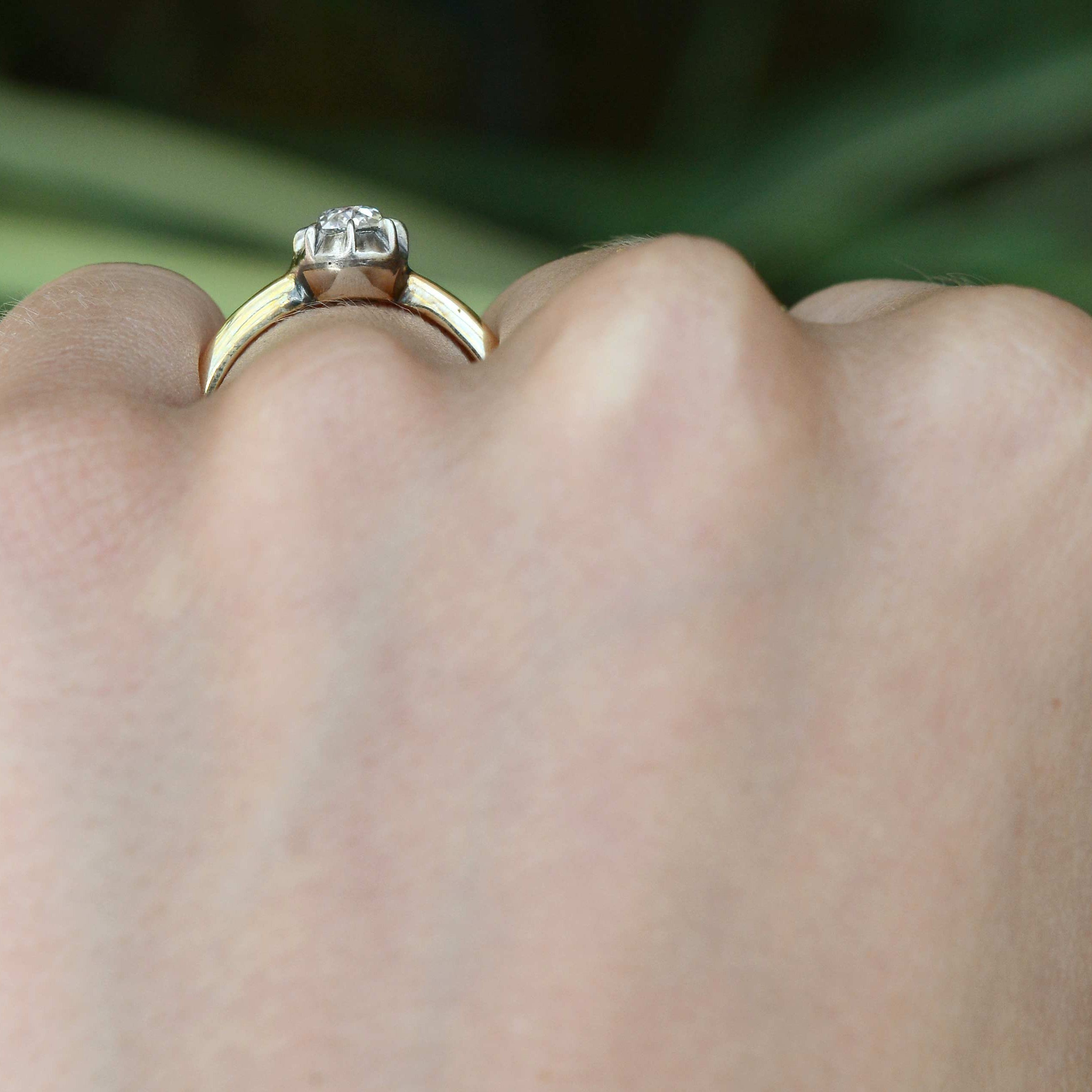 Two tone gold diamond solitaire wedding ring.