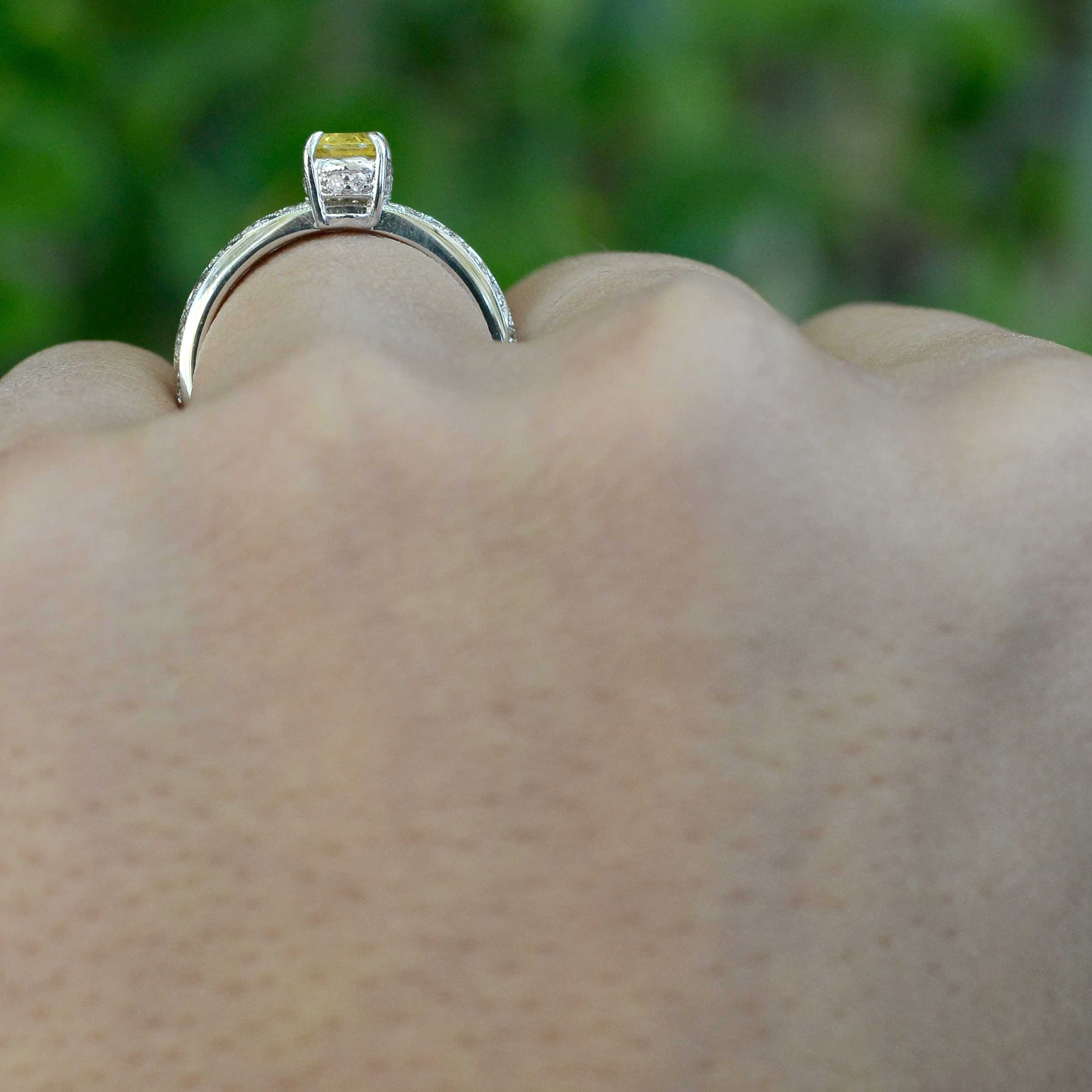 Yellow sapphire 18k white gold engagement ring with a crown setting.
