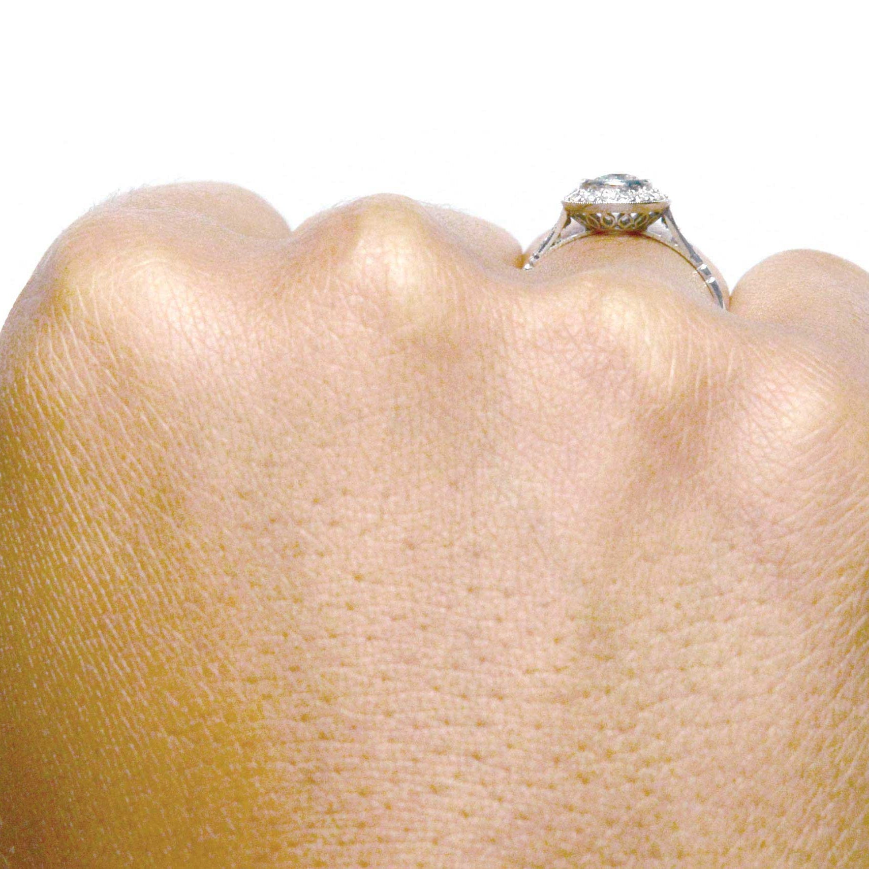 A bezel set diamond is in this engagement ring.